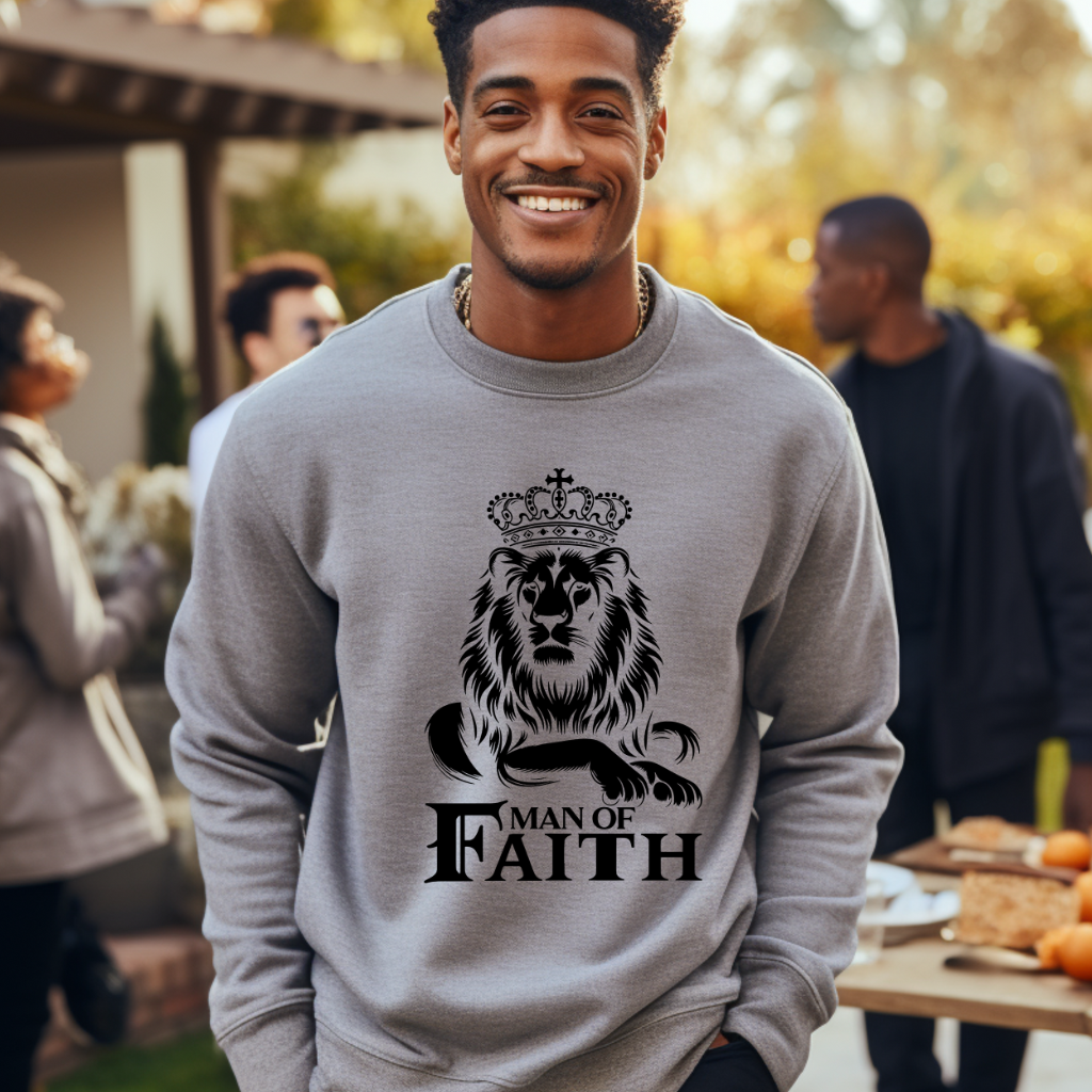 Man wearing a  grey 'Man of Faith' sweatshirt with a gold Lion of Judah graphic, surrounded by people in an outdoor autumn setting. Christian faith  and Religious Men's Sweater apparel
