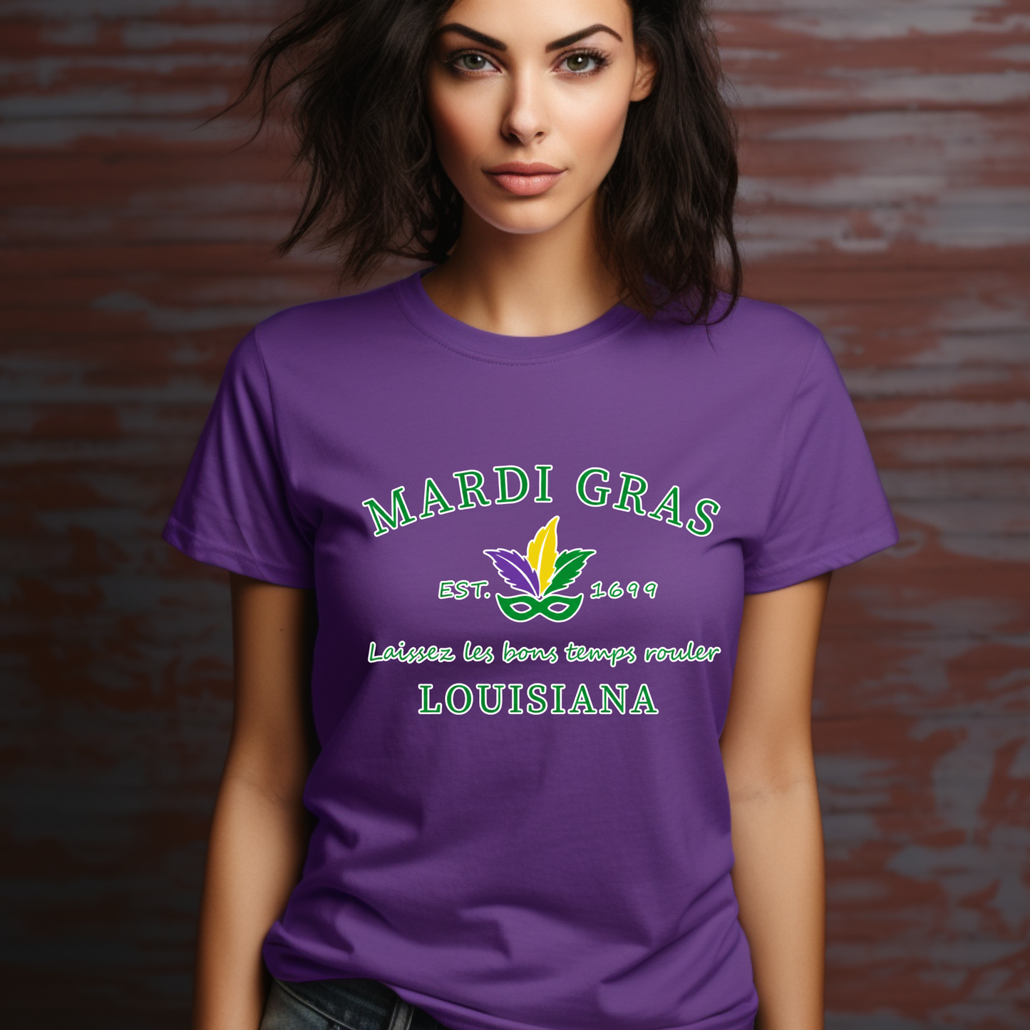 Woman wearing a purple Mardi Gras t-shirt with green text and logo against a brick wall.