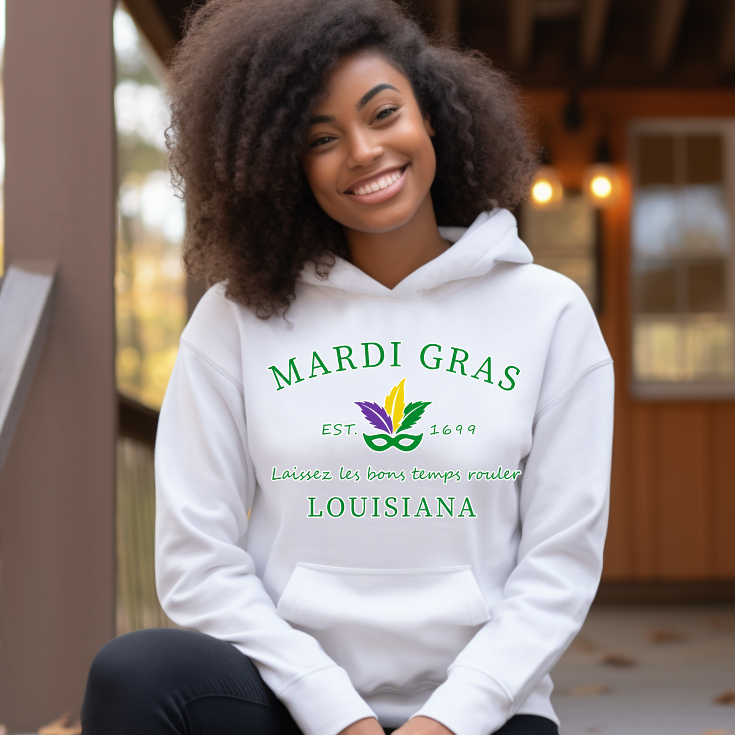 Person wearing a white hoodie with Mardi Gras Louisiana text and design.