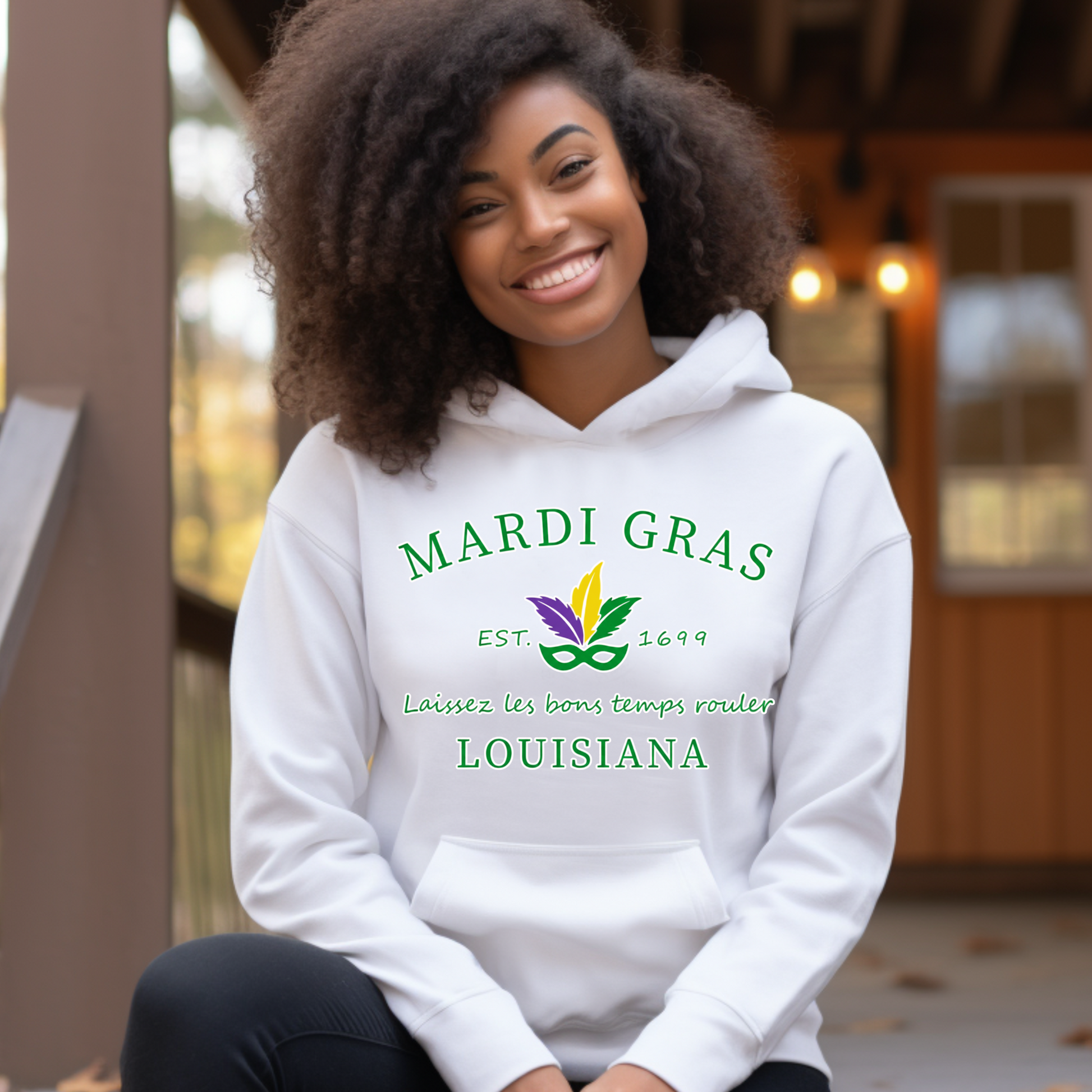 Person wearing a white hoodie with Mardi Gras Louisiana text and design.