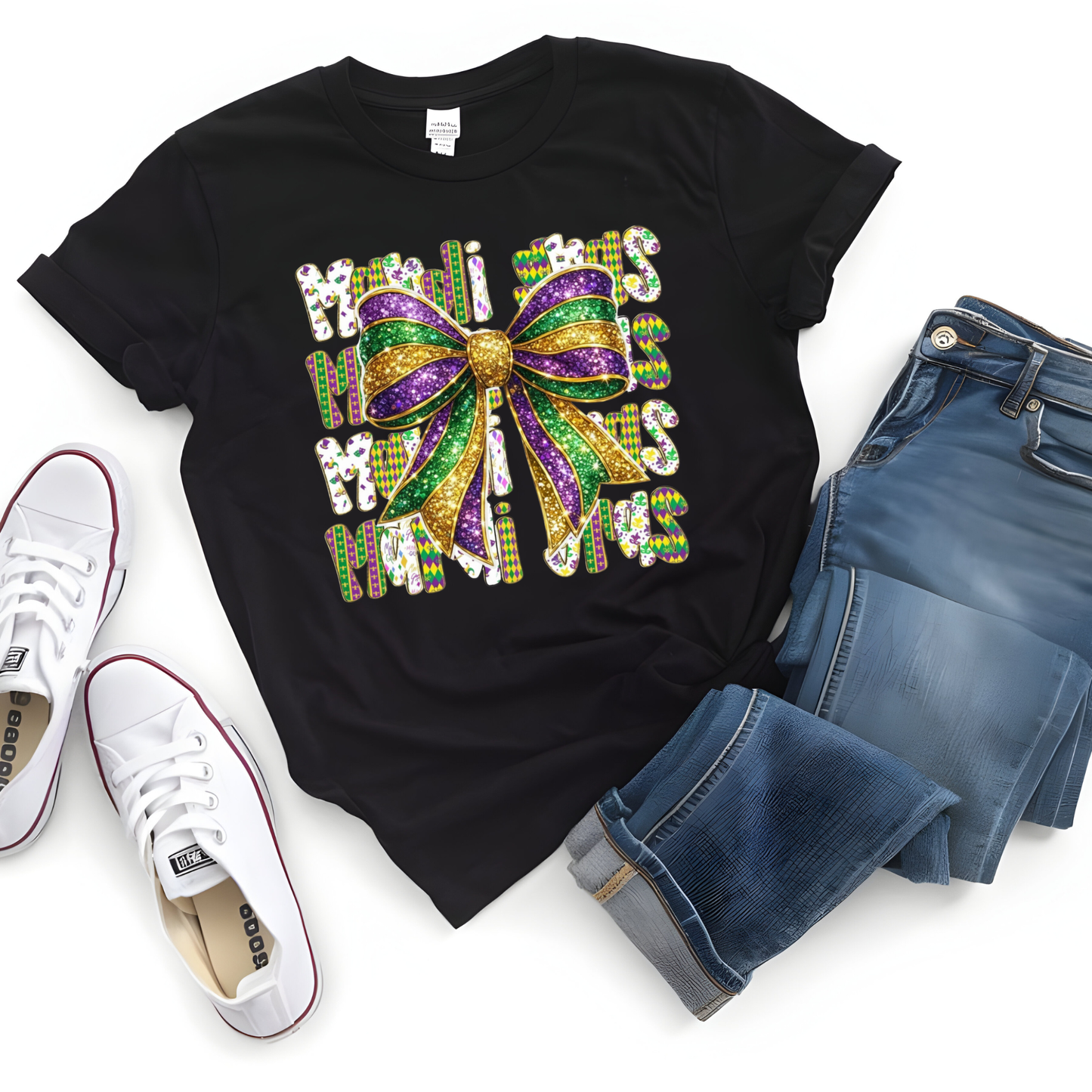 Black t-shirt with colorful bow design, white sneakers, and blue jeans on a white background