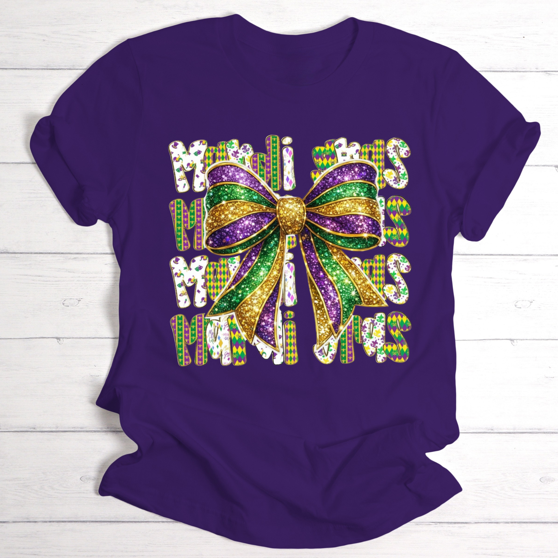 Purple t-shirt with a colorful bow and text design on a wooden surface