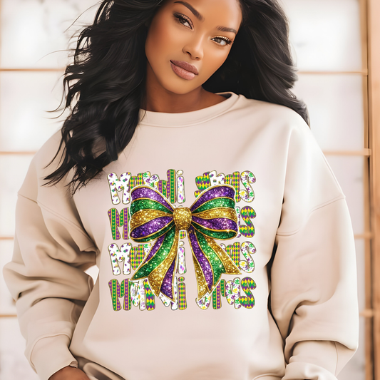 Woman wearing a beige sweatshirt with a colorful bow and text design.