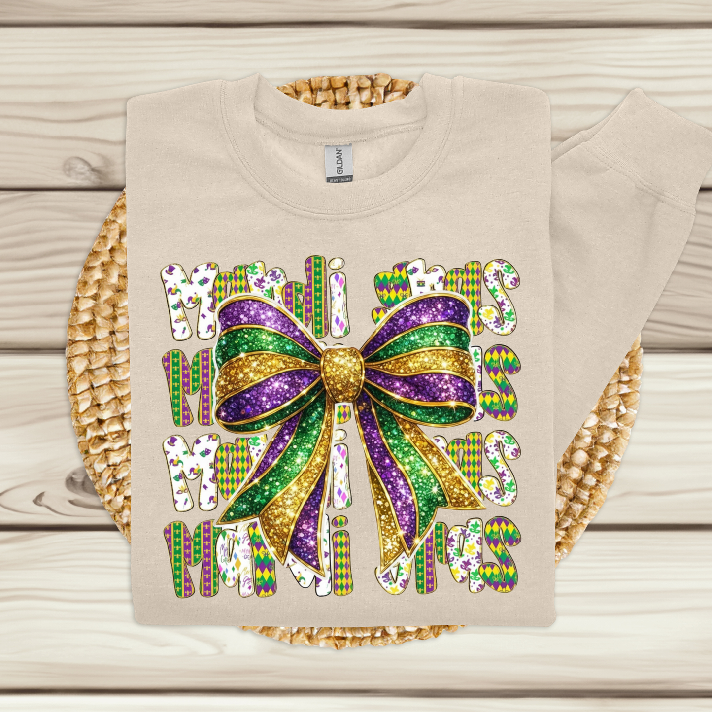 Beige t-shirt with a colorful bow and text design on a wooden surface