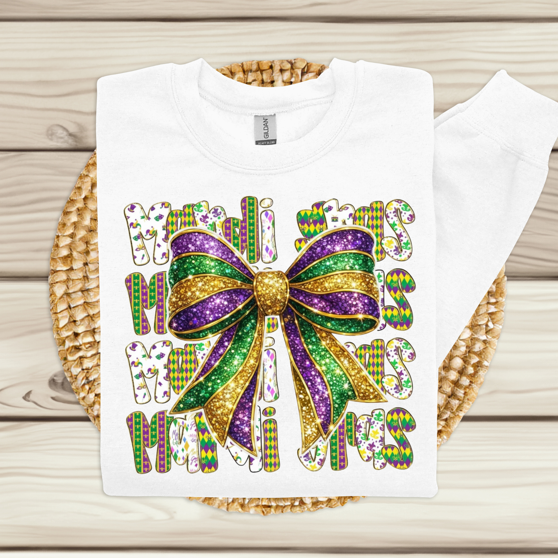 White t-shirt with a colorful bow design and text on a wooden surface