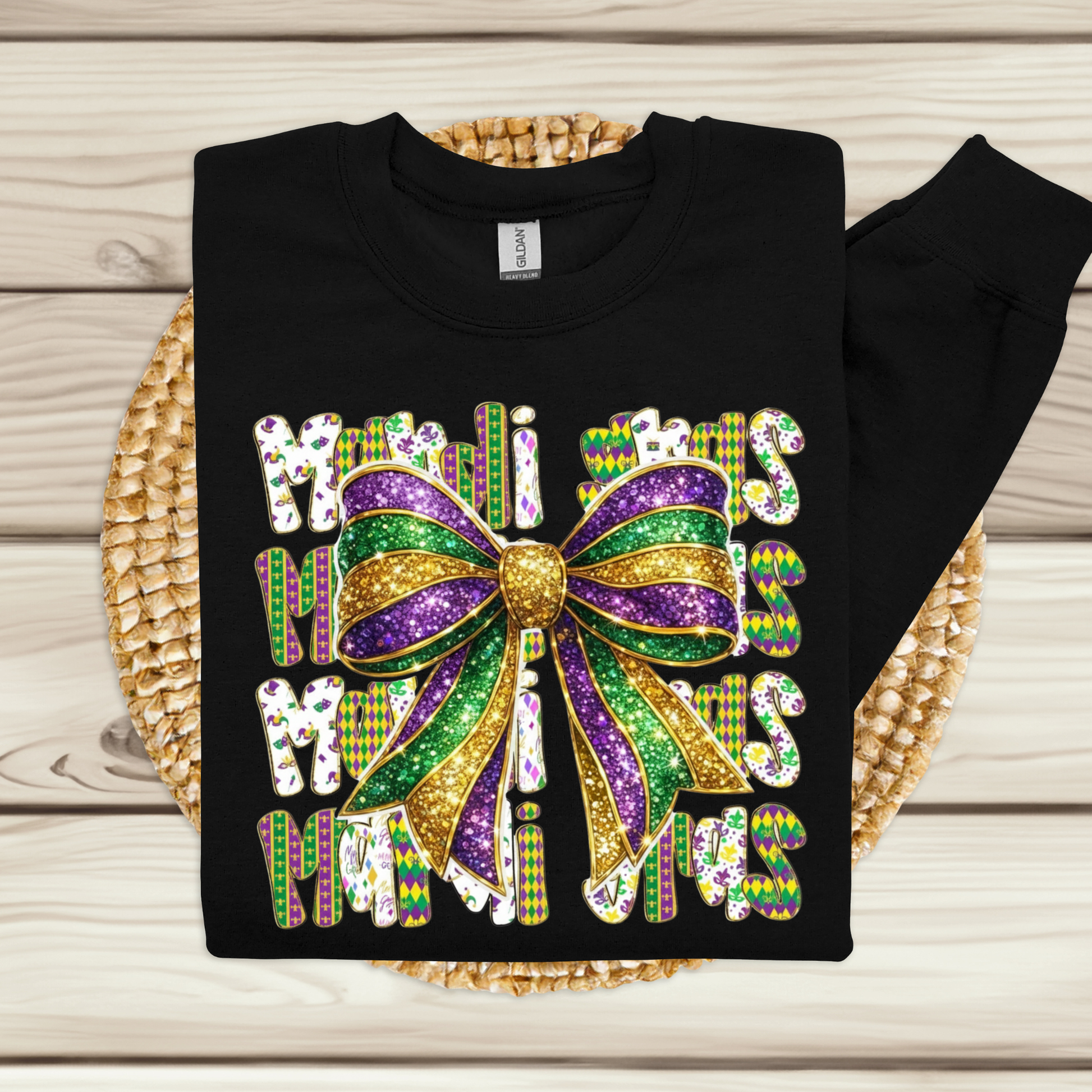 Black sweatshirt with a colorful bow design and text on a wooden surface