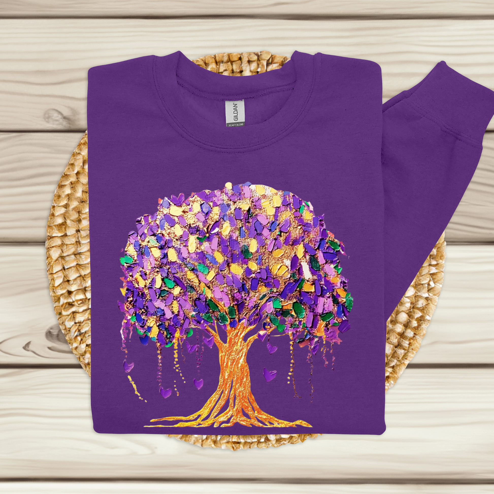 Purple sweatshirt with a colorful tree design on a woven mat