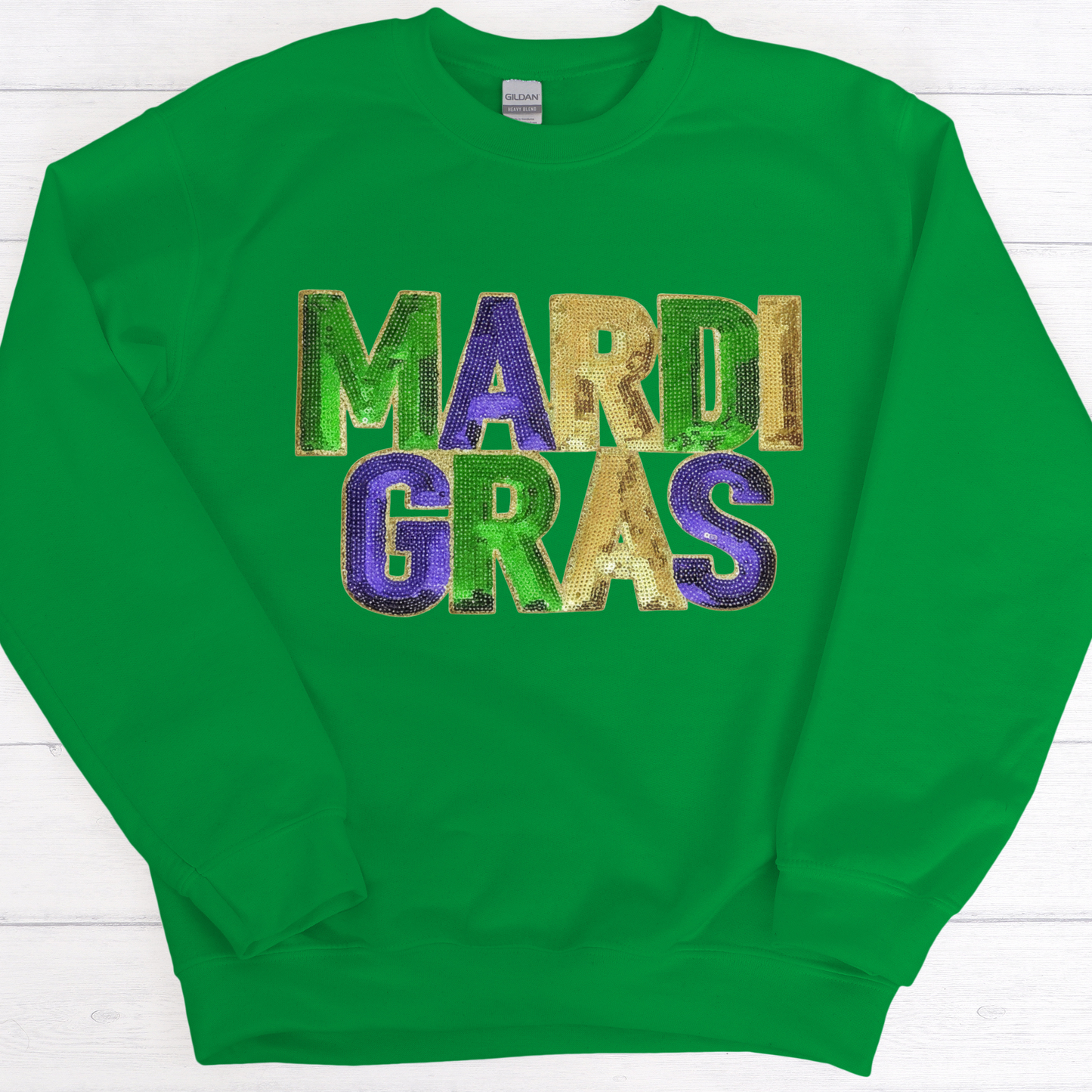 Green sweatshirt with 'Mardi Gras' text in multicolor on a white background