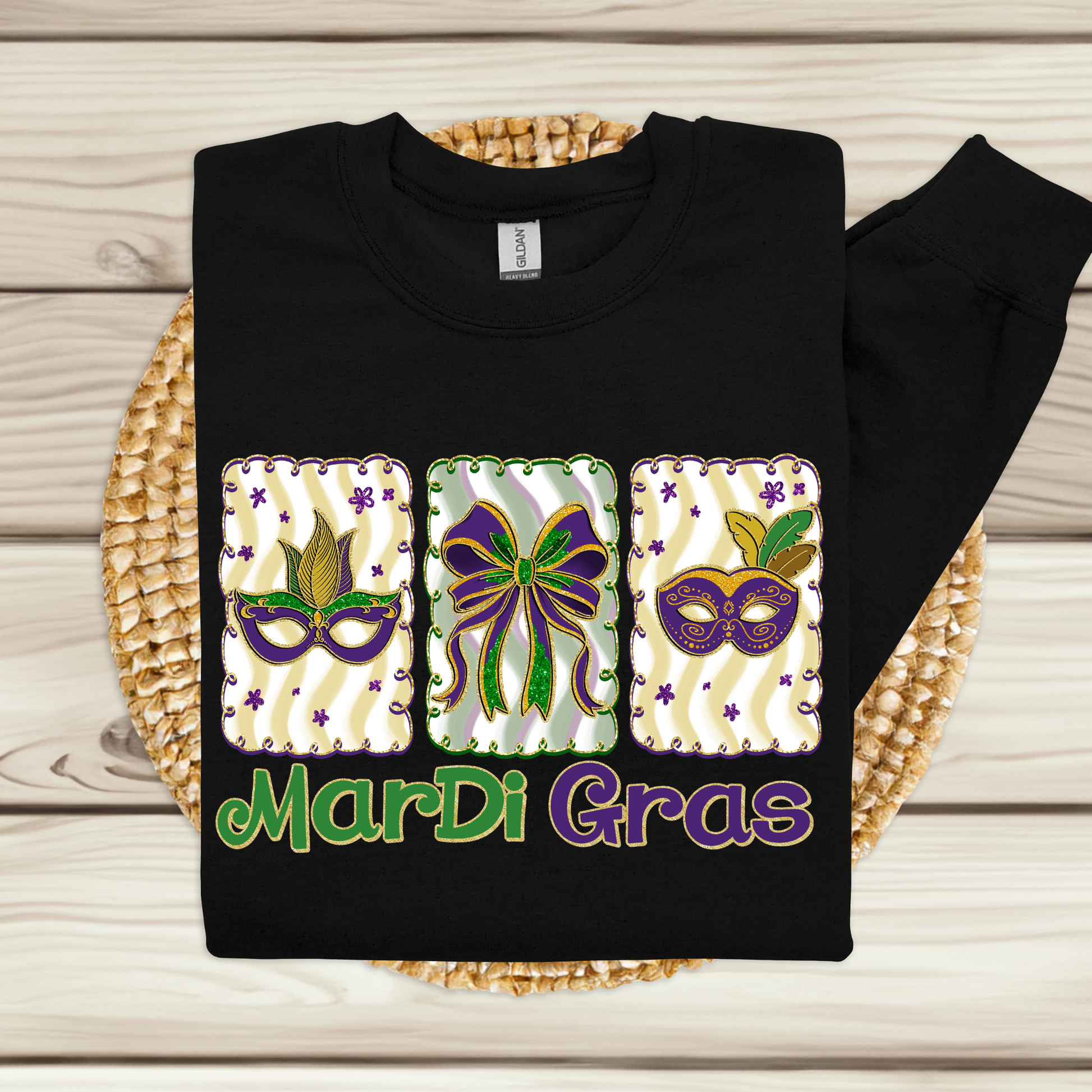 Black sweatshirt with Mardi Gras-themed design on a woven mat