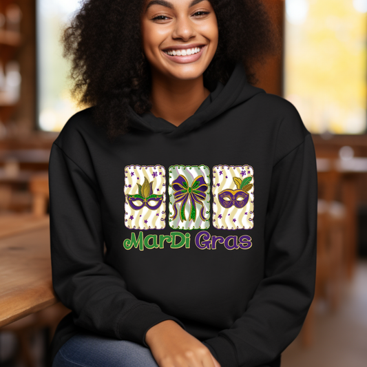 Person wearing a black hoodie with Mardi Gras-themed design
