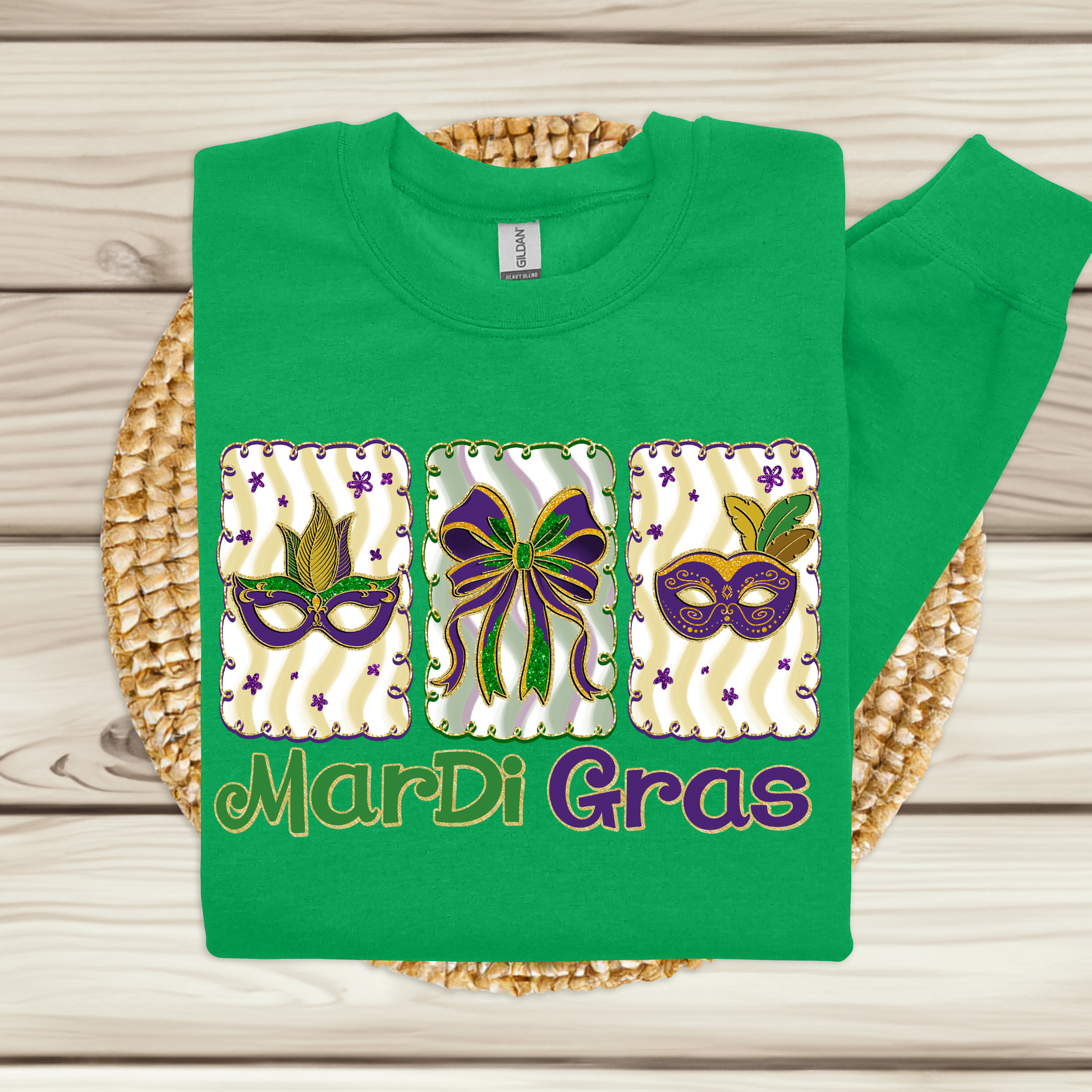Green t-shirt with Mardi Gras-themed designs on a woven mat