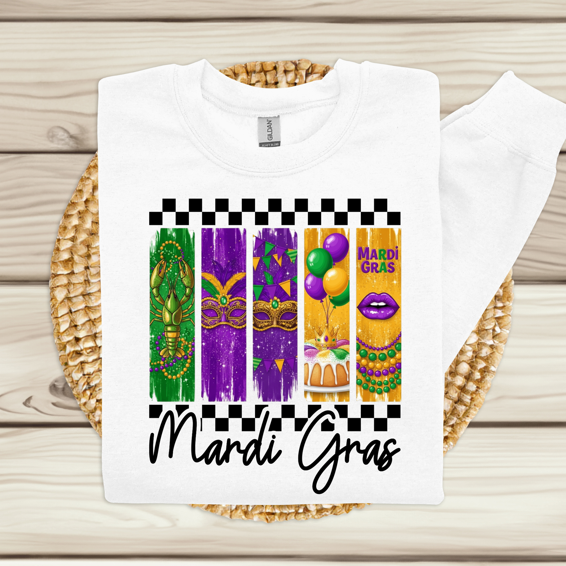 White t-shirt with Mardi Gras-themed design on a woven mat