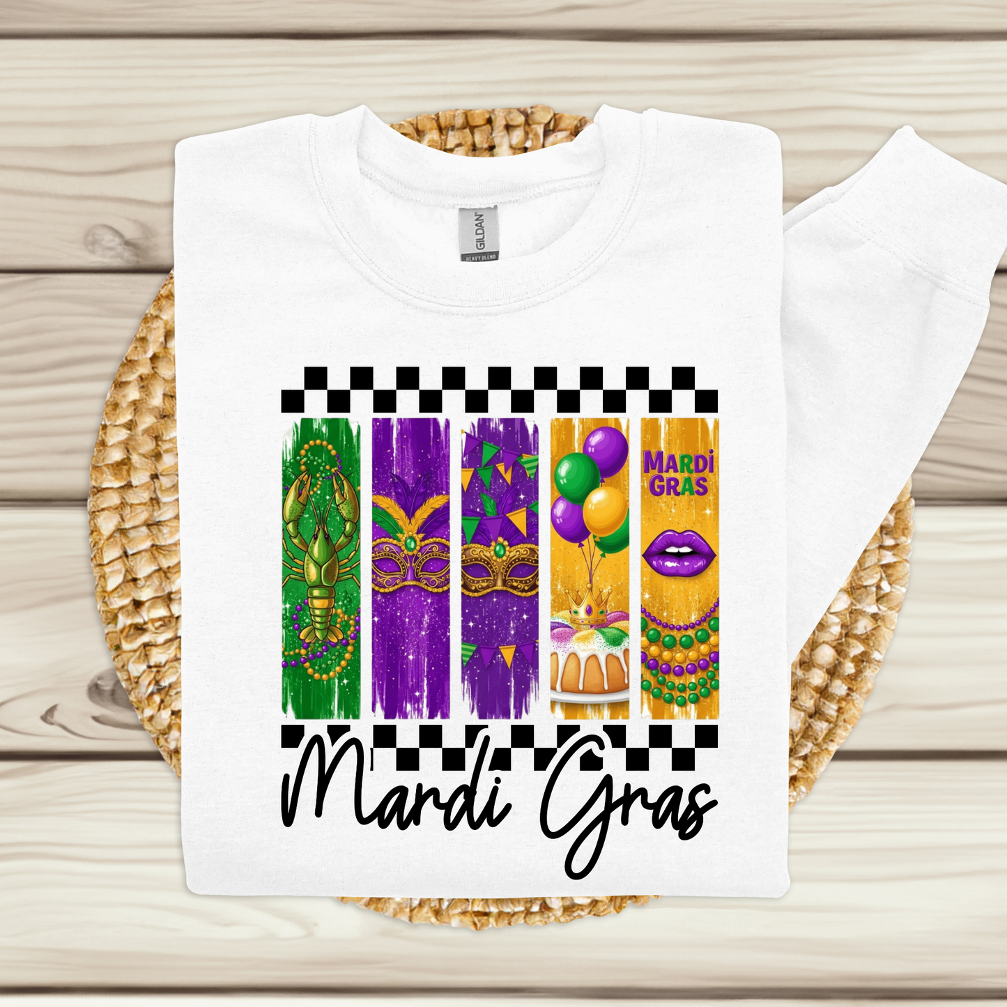 White t-shirt with Mardi Gras-themed design on a woven mat