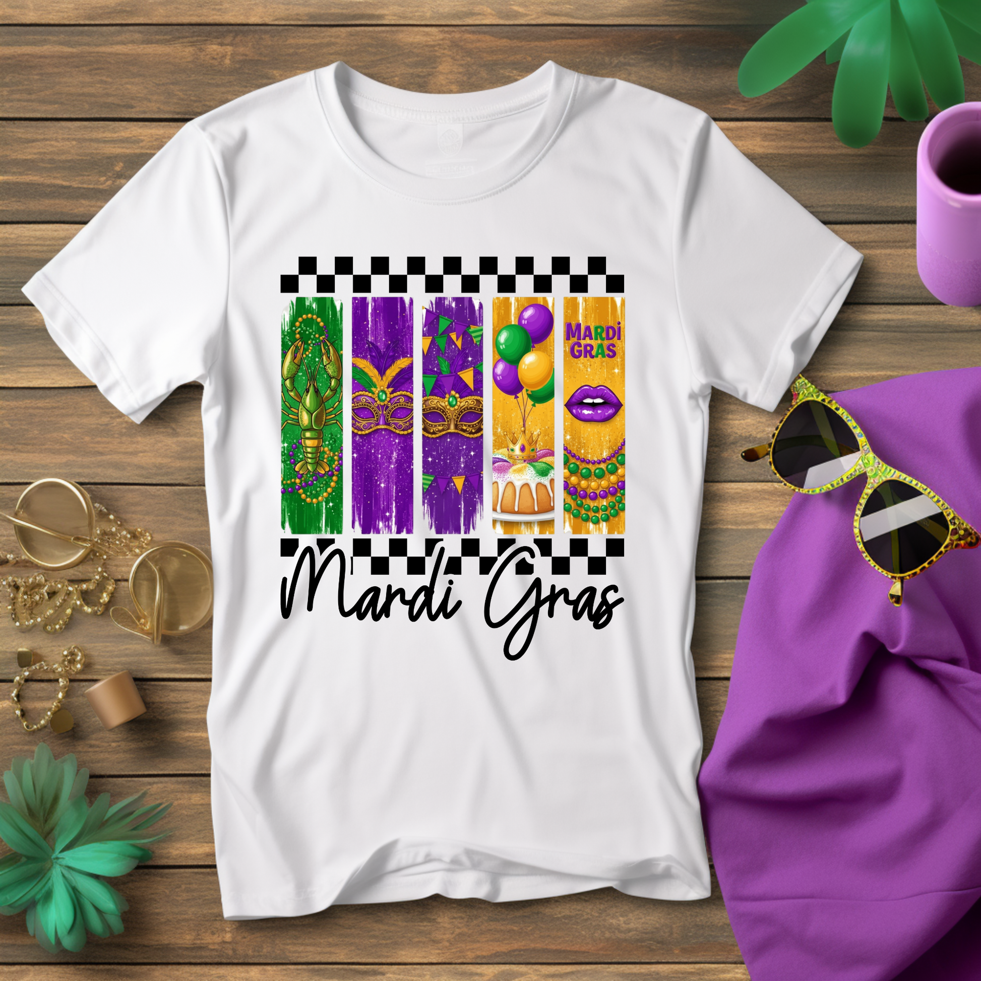 White t-shirt with Mardi Gras-themed design on a wooden surface with accessories.