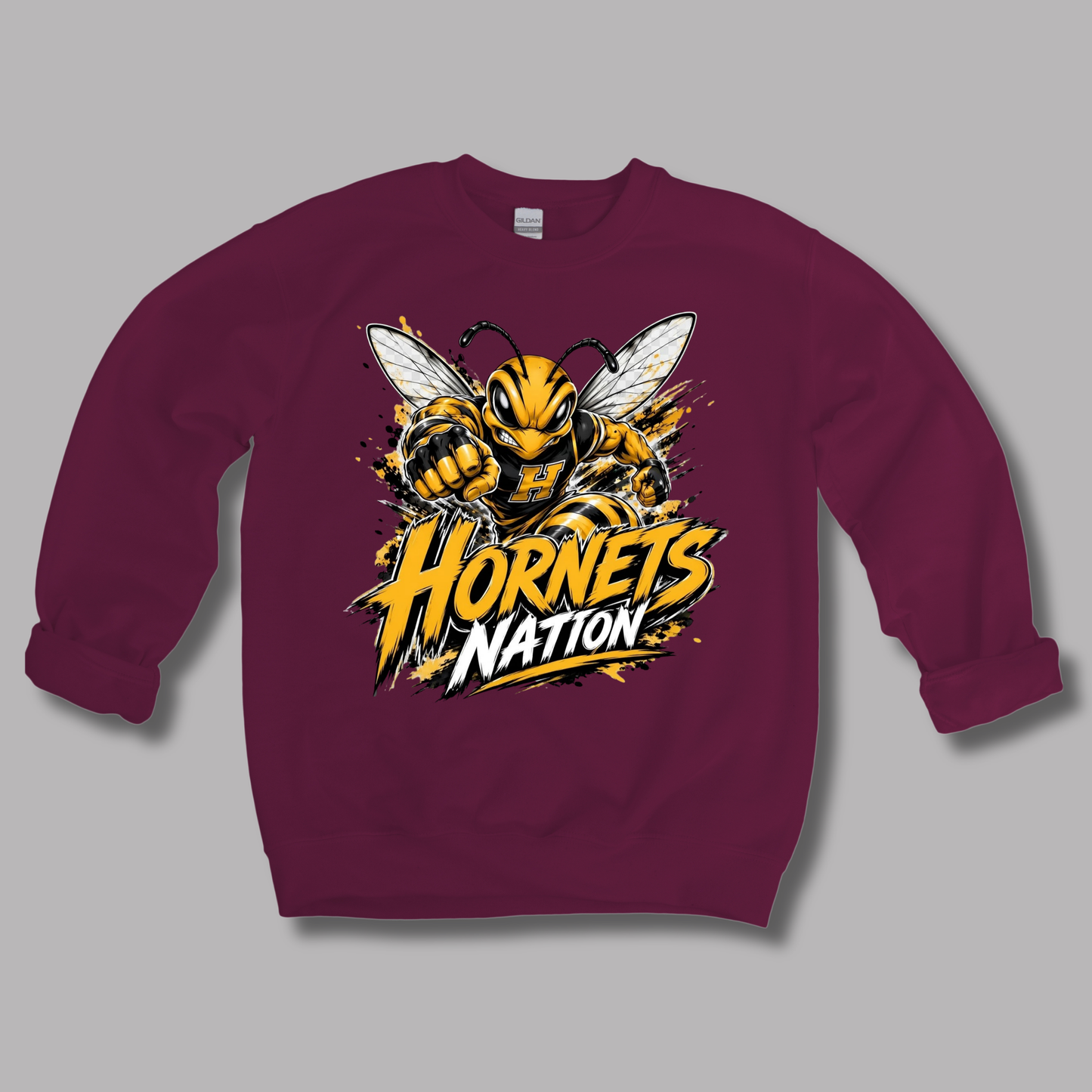 A maroon crewneck sweatshirt featuring a large graphic of a yellow and black hornet with the text 'Hornets Nation' in yellow and white, displayed on a solid gray background.