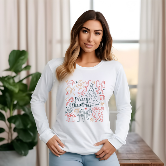 Woman wearing a white long-sleeve shirt with Christmas-themed design indoors.