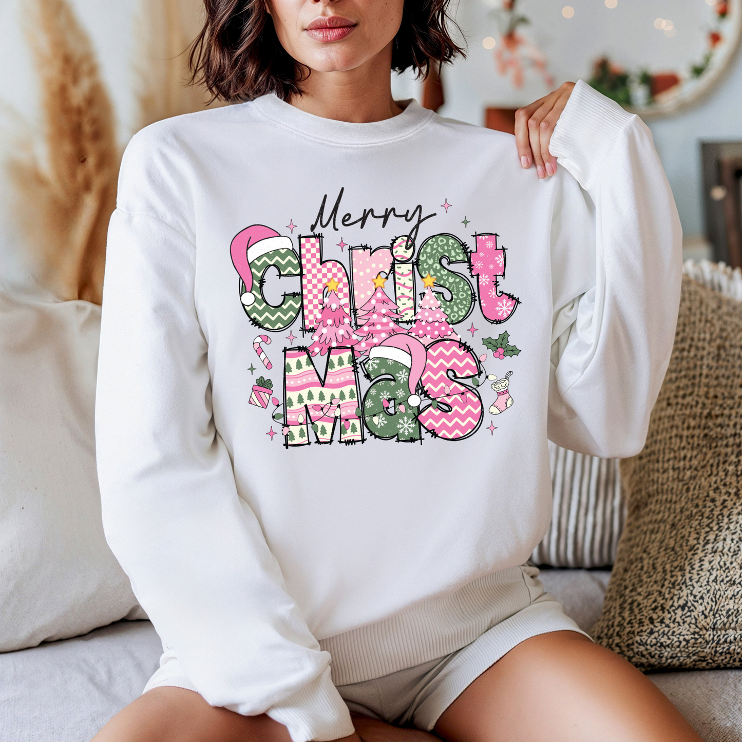 Person wearing a white sweatshirt with 'Merry Christmas' text in colorful letters.