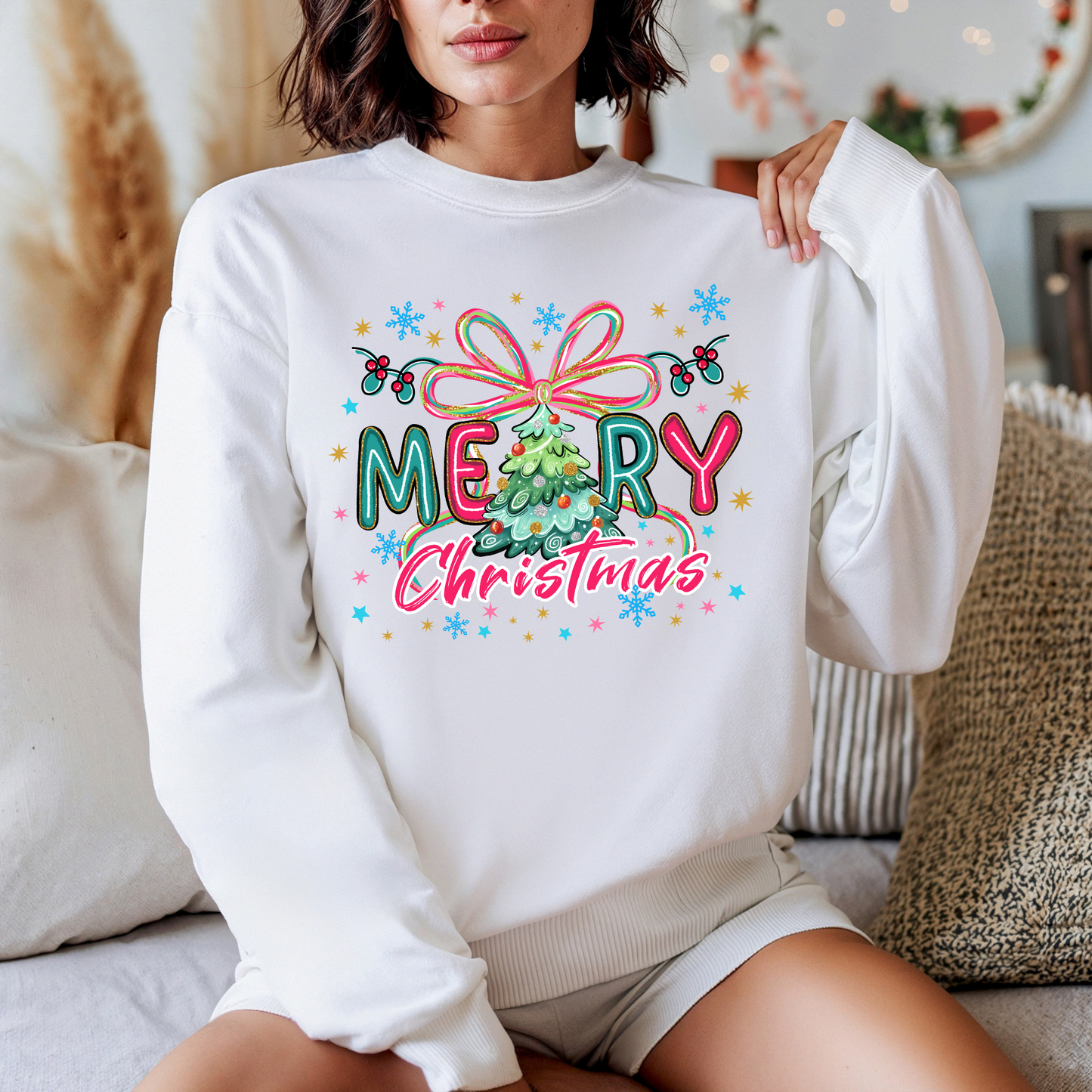 Person wearing a white sweatshirt with a colorful 'Merry Christmas' design.