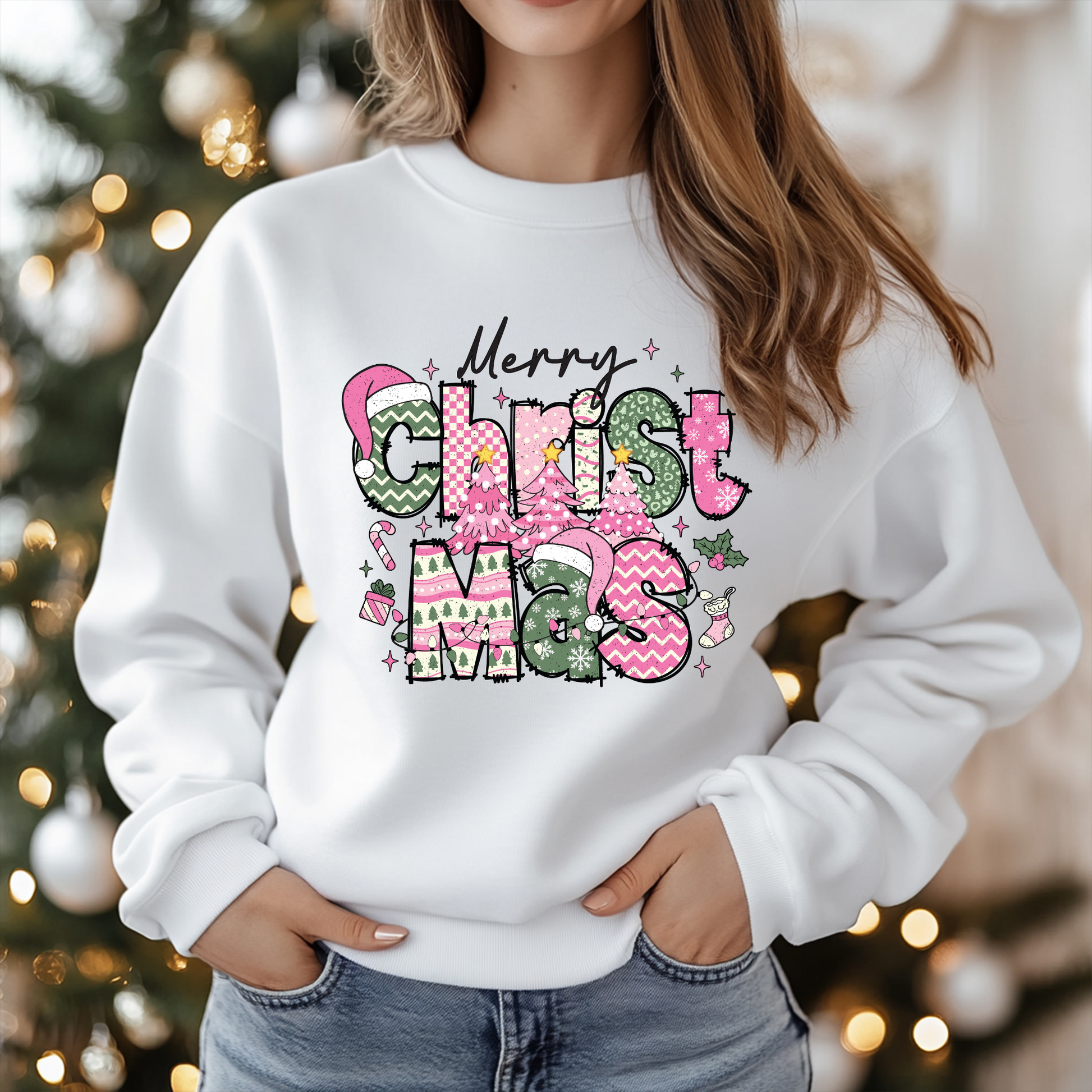 Person wearing a white sweatshirt with 'Merry Christmas' design in front of a decorated Christmas tree.