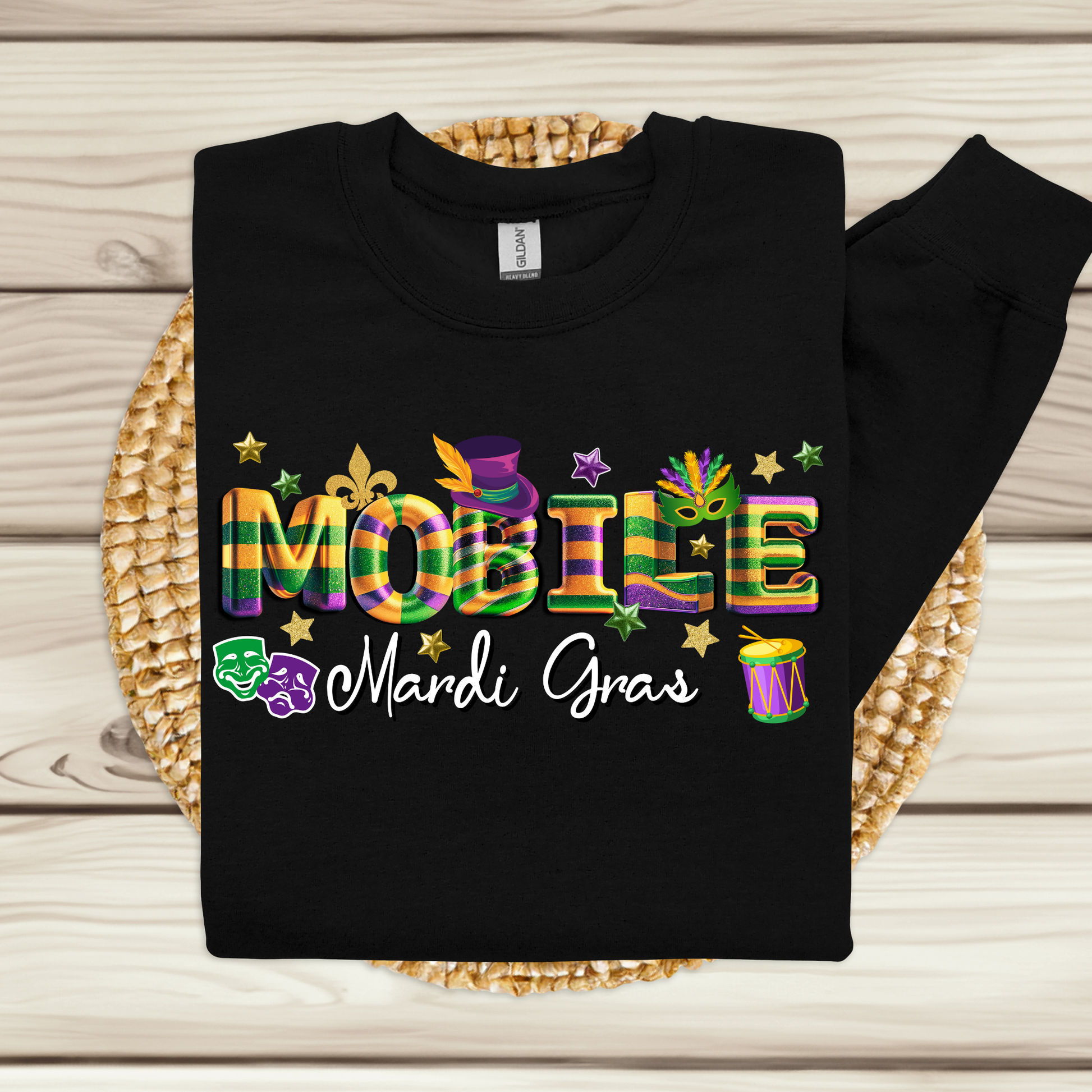 Black sweatshirt with colorful 'Mardi Gras' text on a woven mat