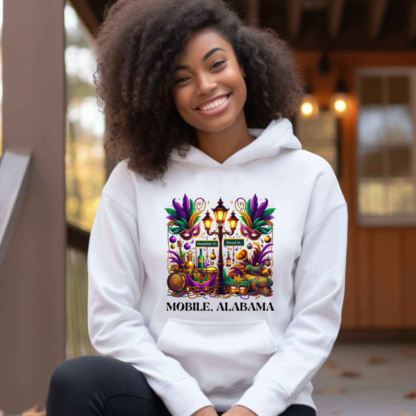 Person wearing a white hoodie with a colorful design and 'Mobile, Alabama' text.