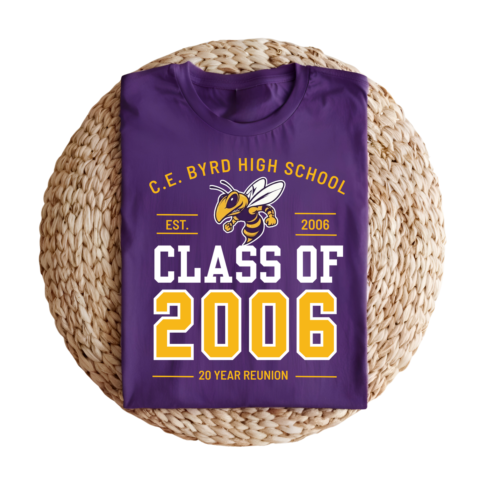 A folded purple t-shirt with a 'Class of 2006' 20-year reunion graphic, displayed on a round woven straw mat against a white background.
