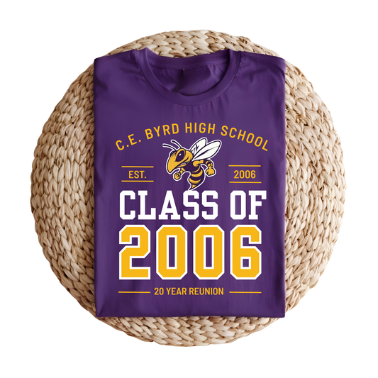 A folded purple t-shirt with a 'Class of 2006' 20-year reunion graphic, displayed on a round woven straw mat against a white background.