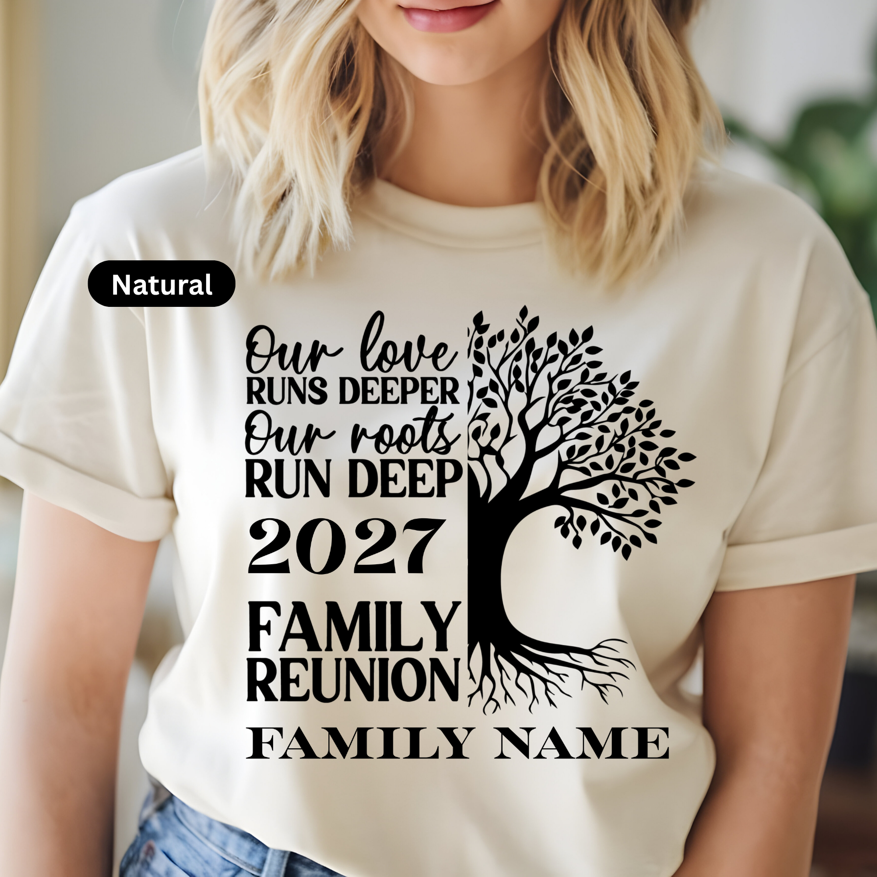 Person wearing a white t-shirt with a tree design and text for a family reunion.