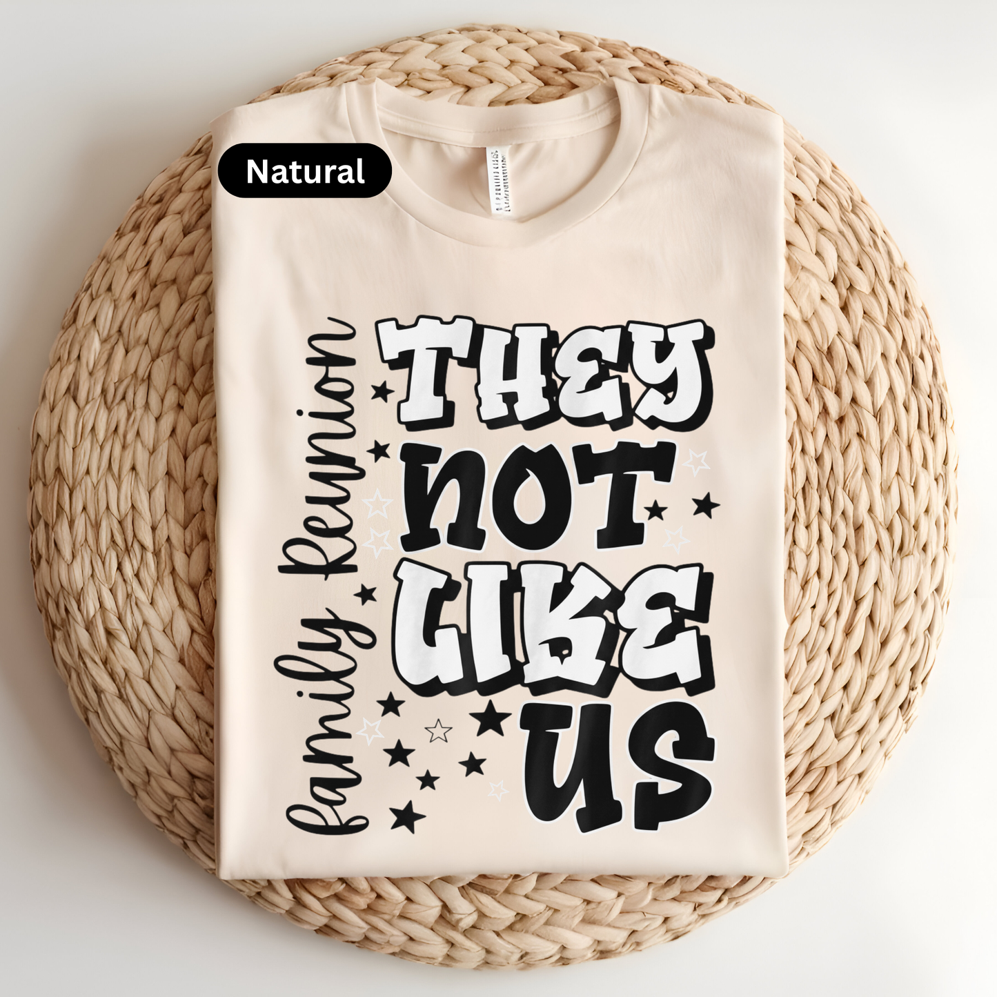 Beige t-shirt with black text on a woven mat