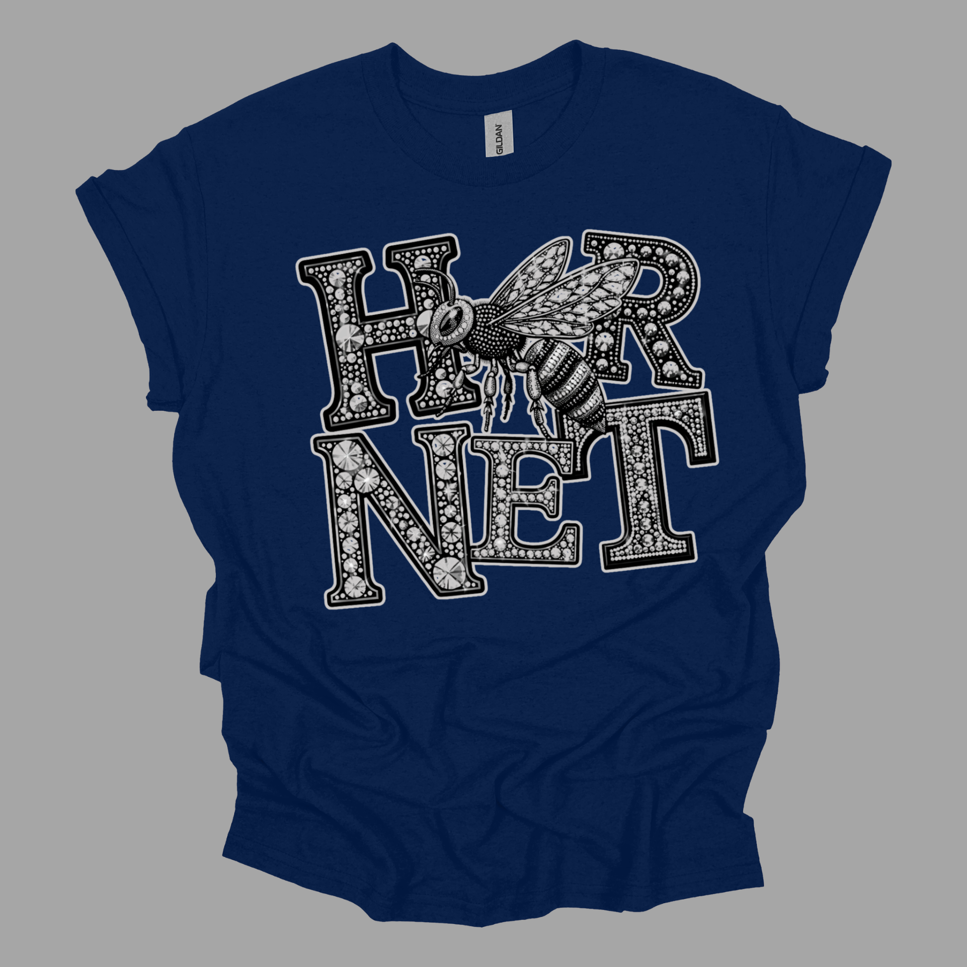 A navy blue short-sleeve t-shirt with a graphic print on the front featuring the word 'HORNET' in ornate black and white letters with a detailed hornet bee overlay, shown on a solid gray background.