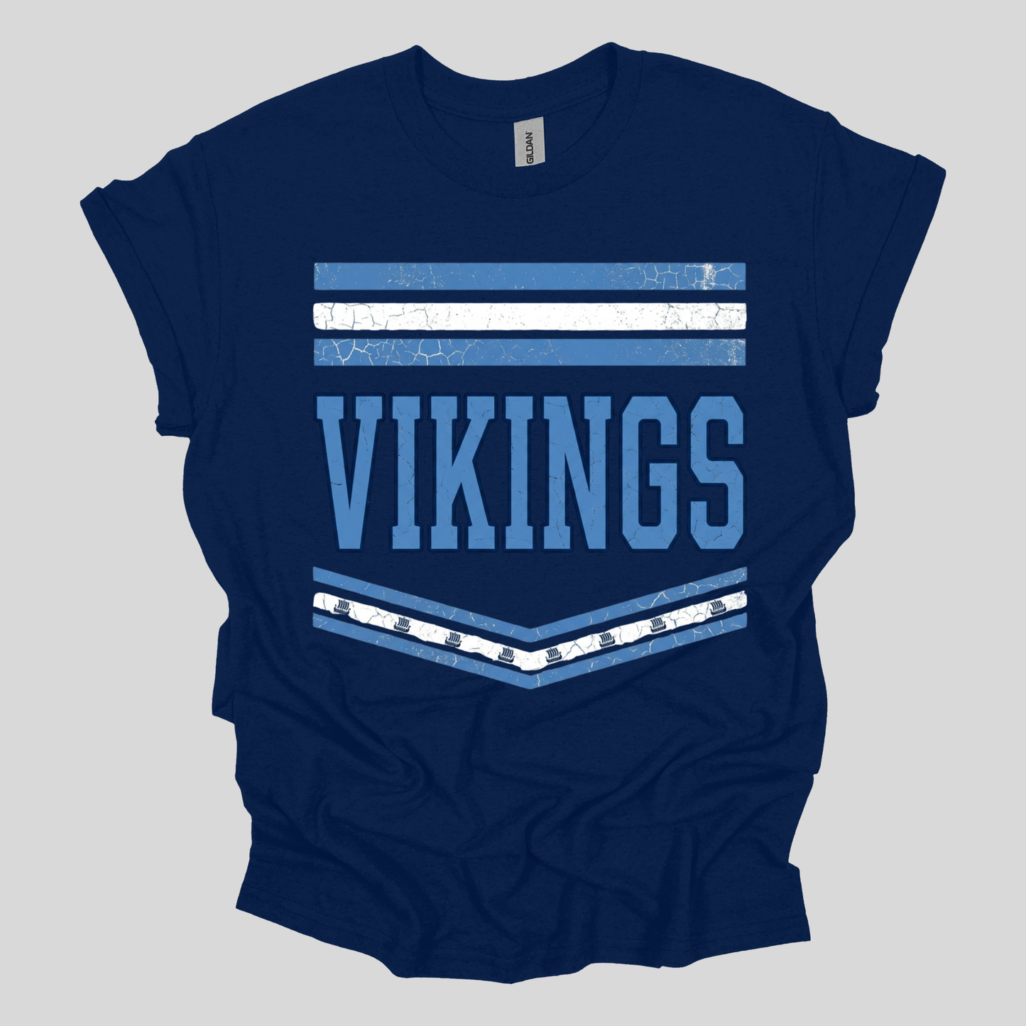 A navy blue short-sleeve t-shirt with a distressed graphic on the front featuring the word 'VIKINGS' in light blue, flanked by white and light blue horizontal stripes.