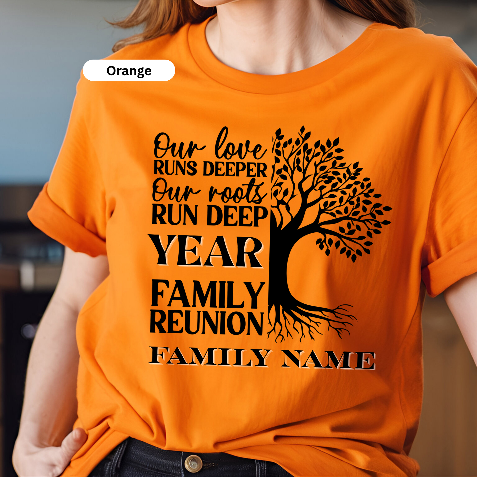 Orange t-shirt with black text and tree design, worn by a person.