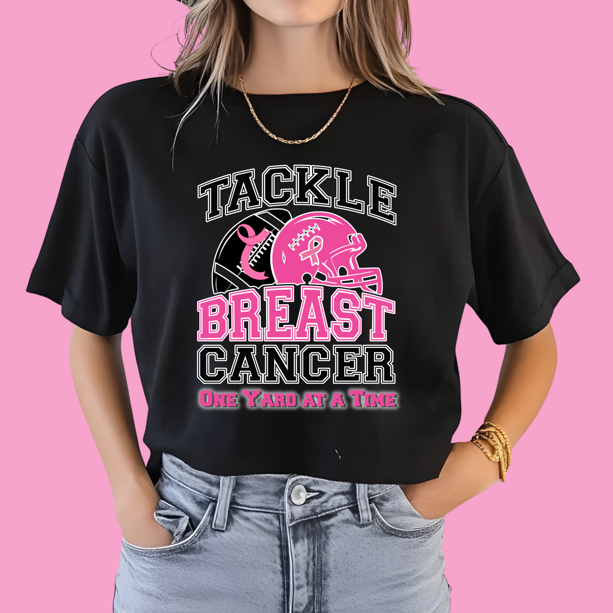 Person wearing a black t-shirt with 'Tackle Breast Cancer One Yard at a Time' design on a pink background  October Awareness Shirt - Tackle for a Cause One Yard at a Time Tee