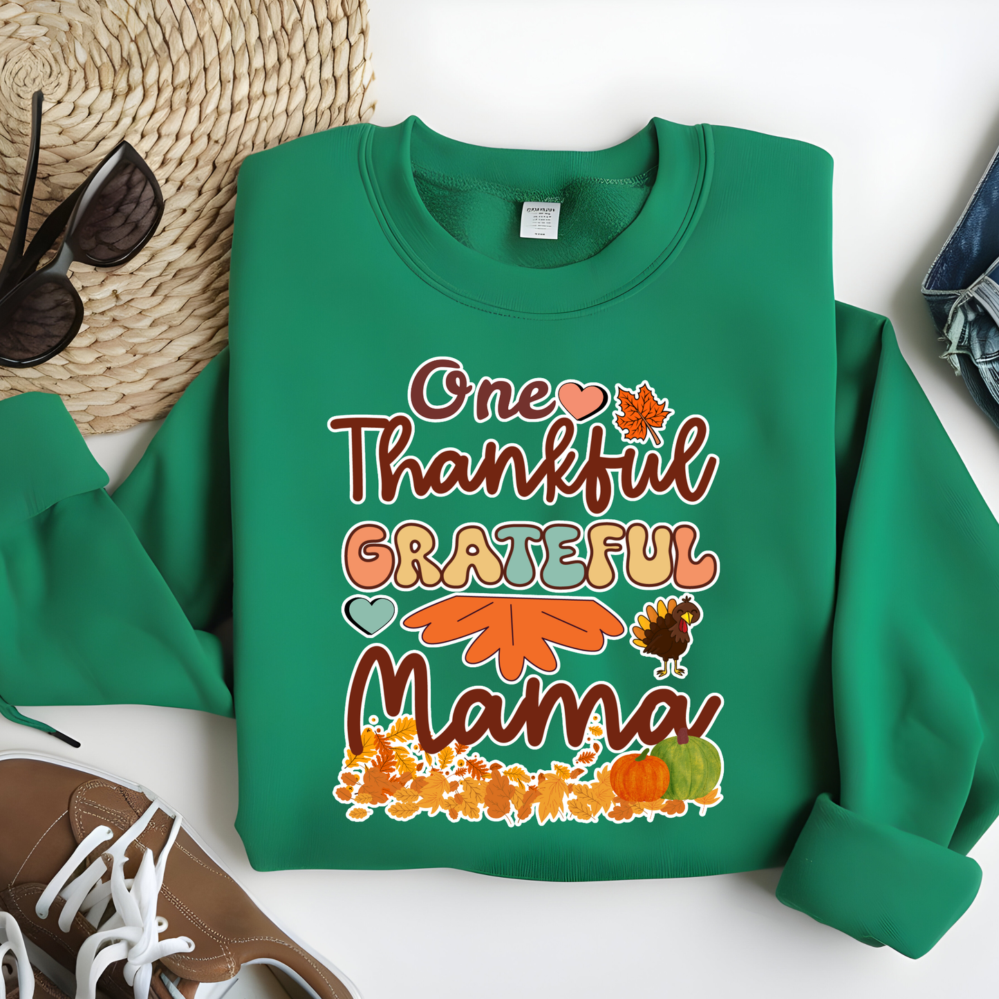   Green sweatshirt with 'One Thankful Grateful Mama' text and fall-themed graphics on a white surface.  Retro Thanksgiving Sweatshirt "One Thankful Mama" Cozy Fall Mom Crewneck