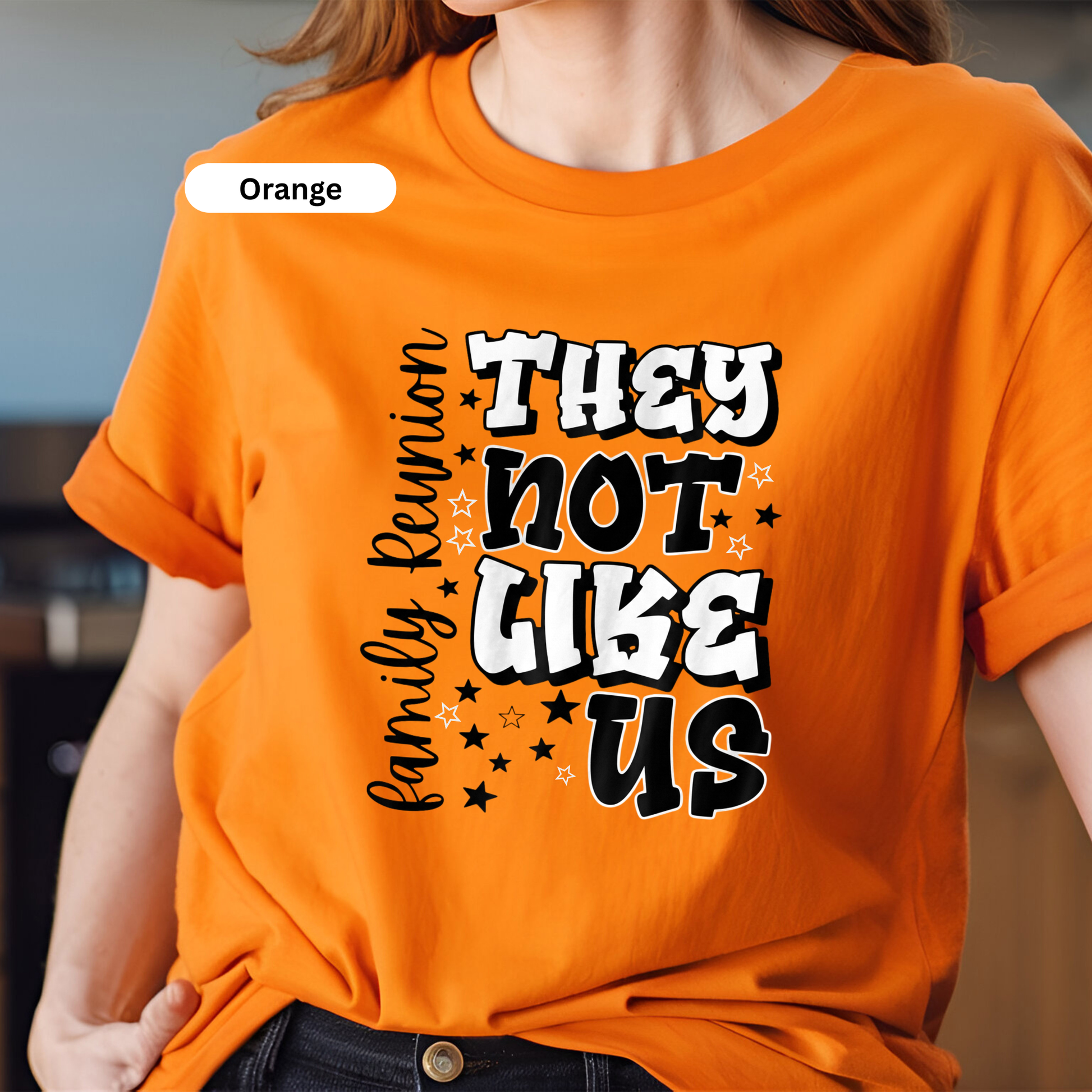 Person wearing an orange t-shirt with text design