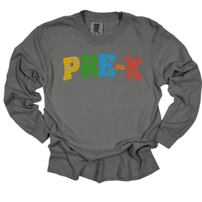 A dark gray long-sleeve t-shirt with the word 'PREK' printed across the chest in colorful, textured block letters (yellow, green, blue, orange, red).