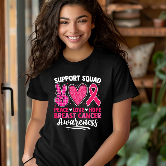 Person wearing a black t-shirt with breast cancer awareness design Pink Ribbon T-Shirt: Support Squad Peace Love Hope -  Support Tee