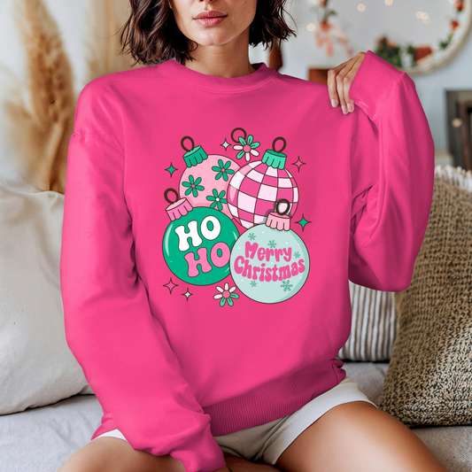Person wearing a pink sweatshirt with Christmas-themed design