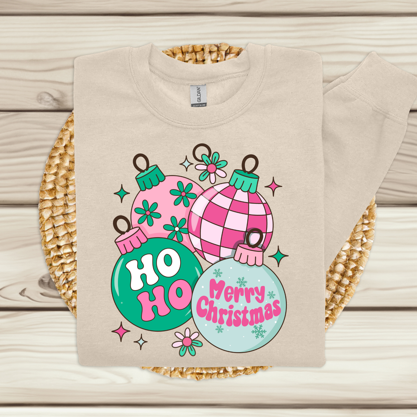 Beige sweatshirt with Christmas-themed design on a woven mat