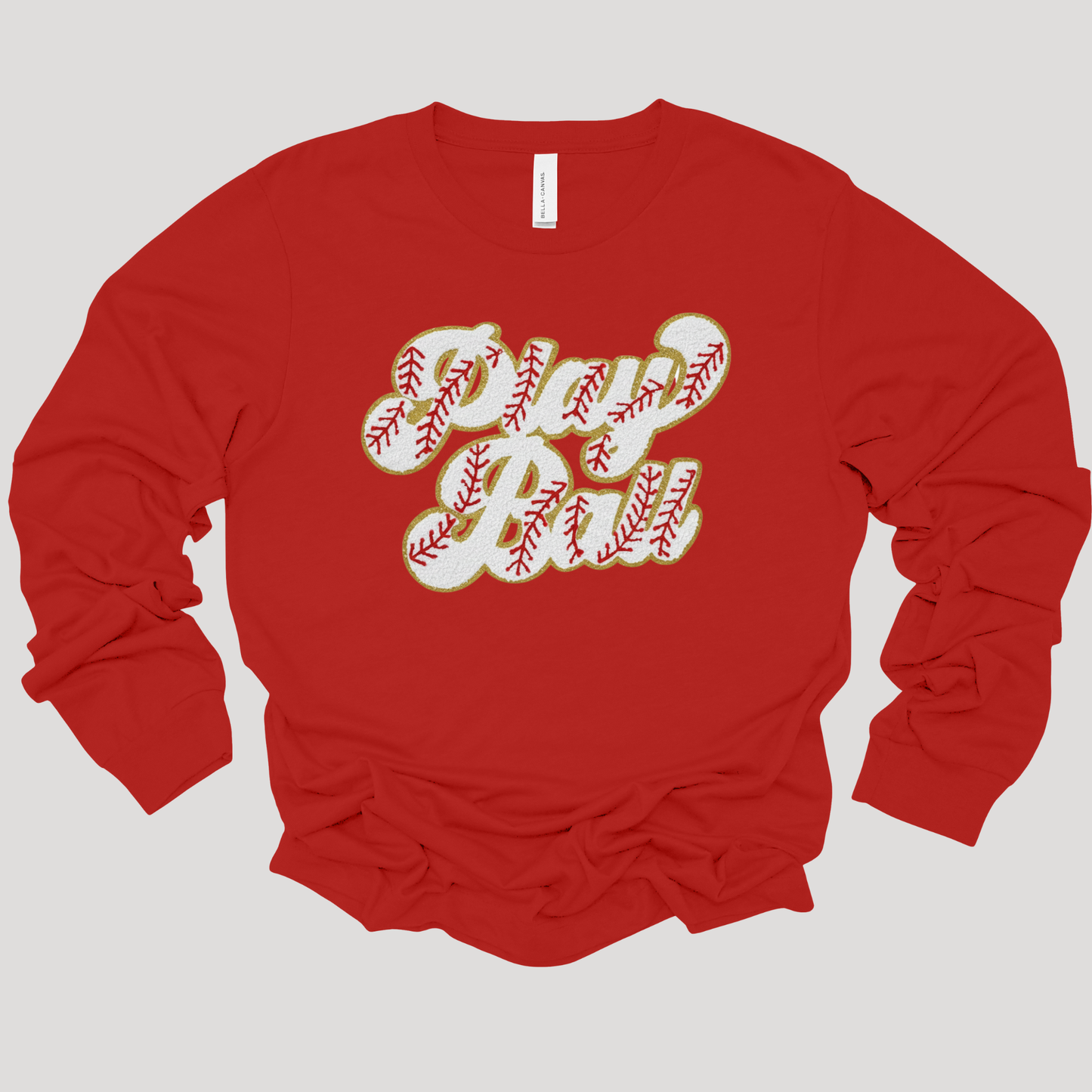 Red long-sleeve shirt with 'Dad' printed in baseball-themed text on a light gray background