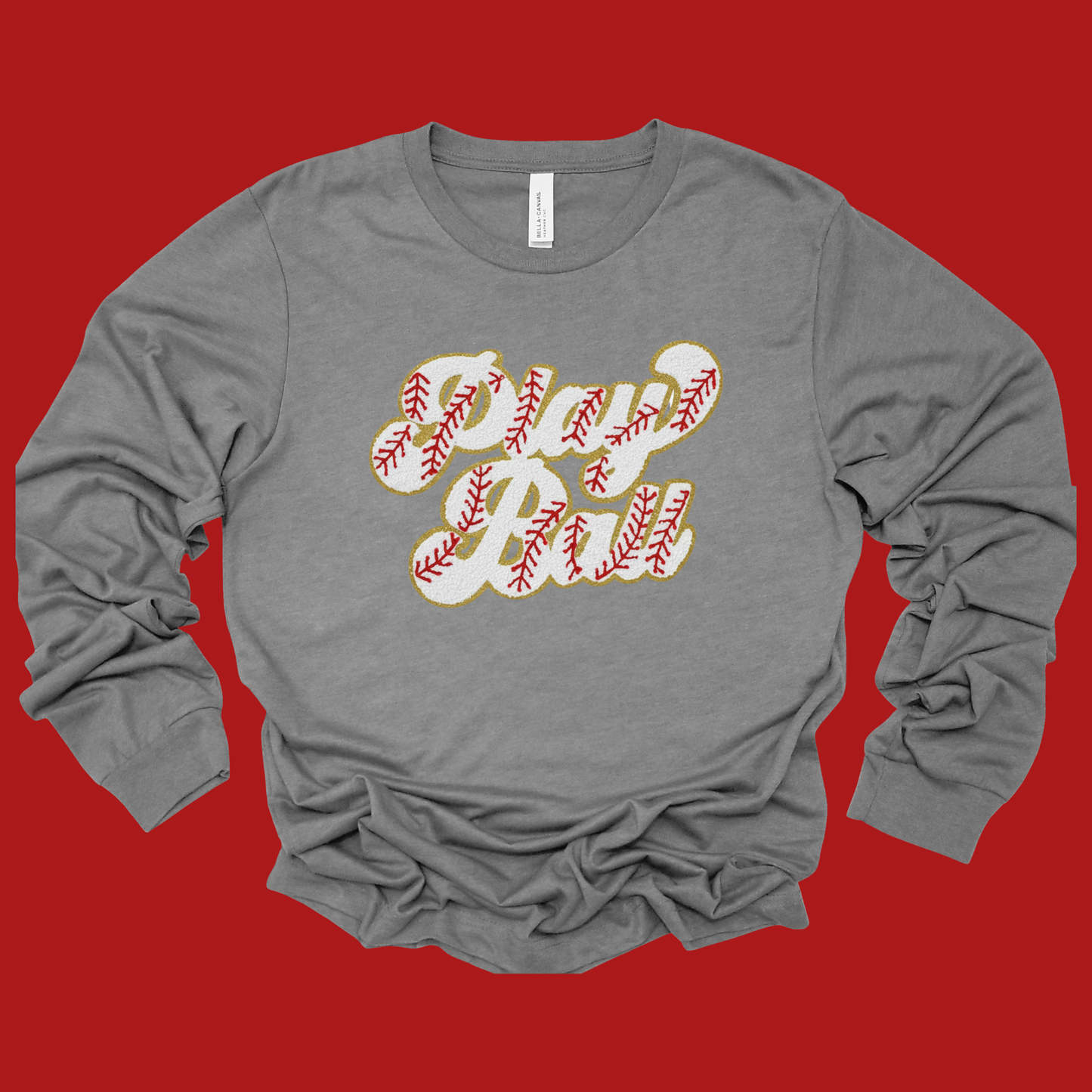 Gray long-sleeve shirt with baseball-themed design on a red background