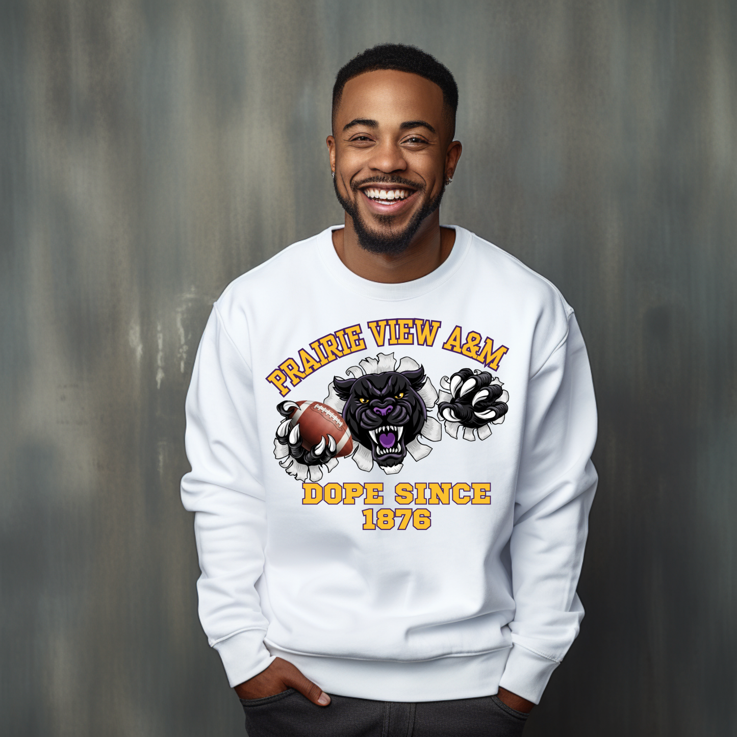 A smiling man wearing a white crewneck sweatshirt with a graphic print of a black panther, football, and the text 'Prairie View A&M DOPE SINCE 1876' against a textured gray background.