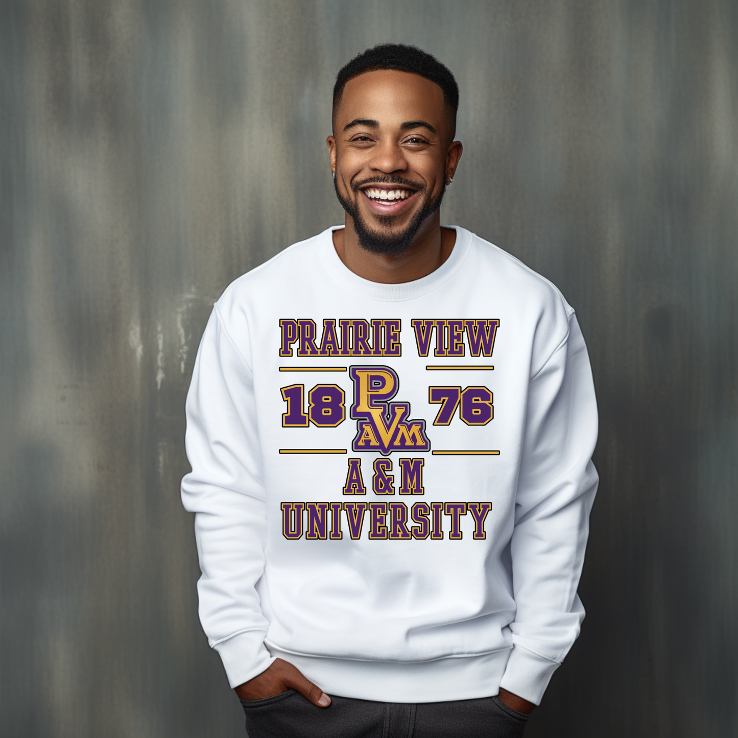 A smiling man wearing a white crewneck sweatshirt with a purple and gold graphic that reads 'PRAIRIE VIEW 1876 A&N UNIVERSITY' and 'Pfam' in the center, posed against a textured gray studio background.