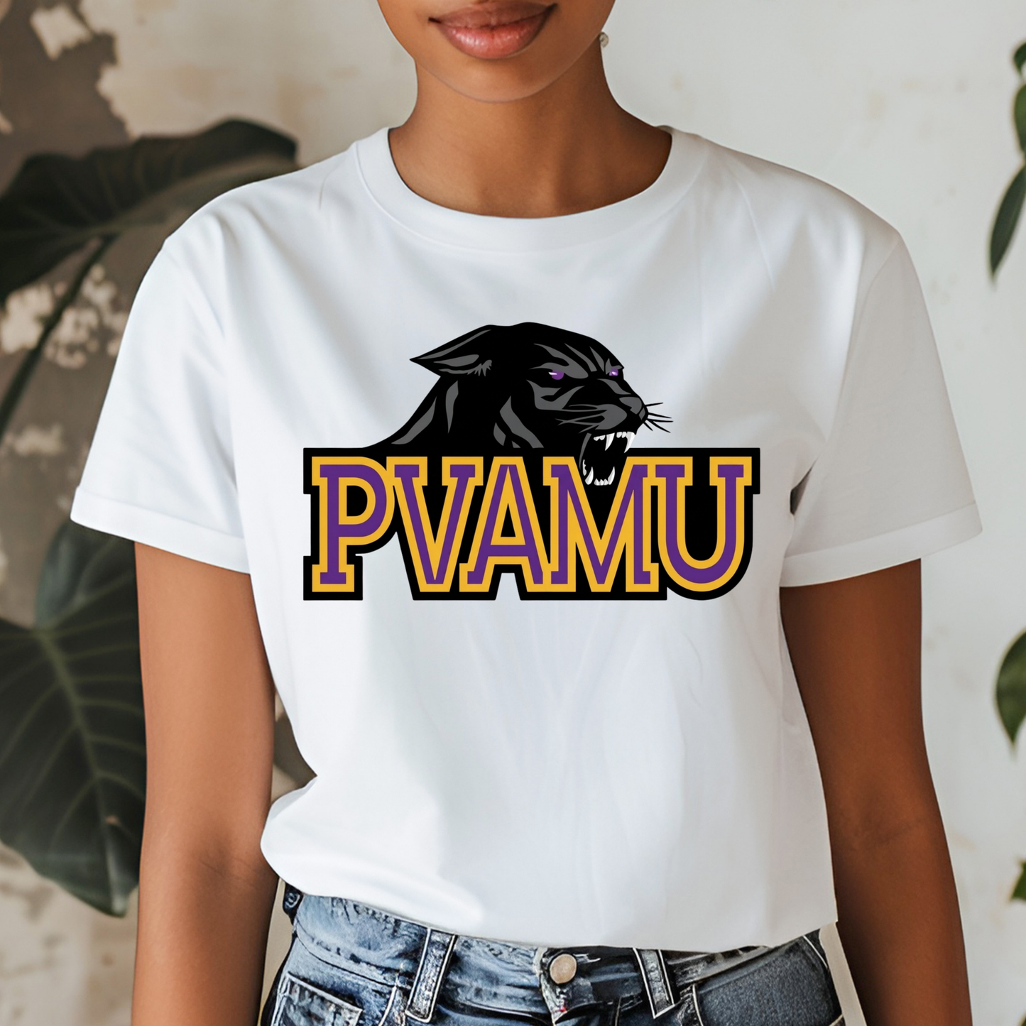 A white short-sleeve graphic t-shirt worn by a model. The shirt features a black panther graphic above the text 'PVAMU' in purple and gold block letters.