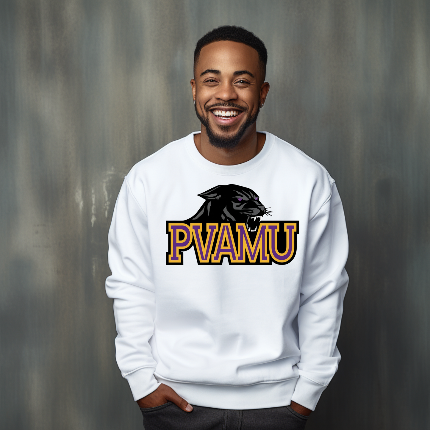A smiling man wearing a white crewneck sweatshirt with a black panther graphic and the text 'PVAMU' in yellow and orange outlined letters, standing against a textured gray background.