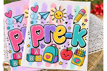 Two colorful square canvas prints featuring a playful 'pre-k' school theme with hand-drawn cartoon letters, a smiling sun, paper airplanes, stars, blocks, a backpack, an apple, and crayons, displayed on a wicker tray over a lace doily.
