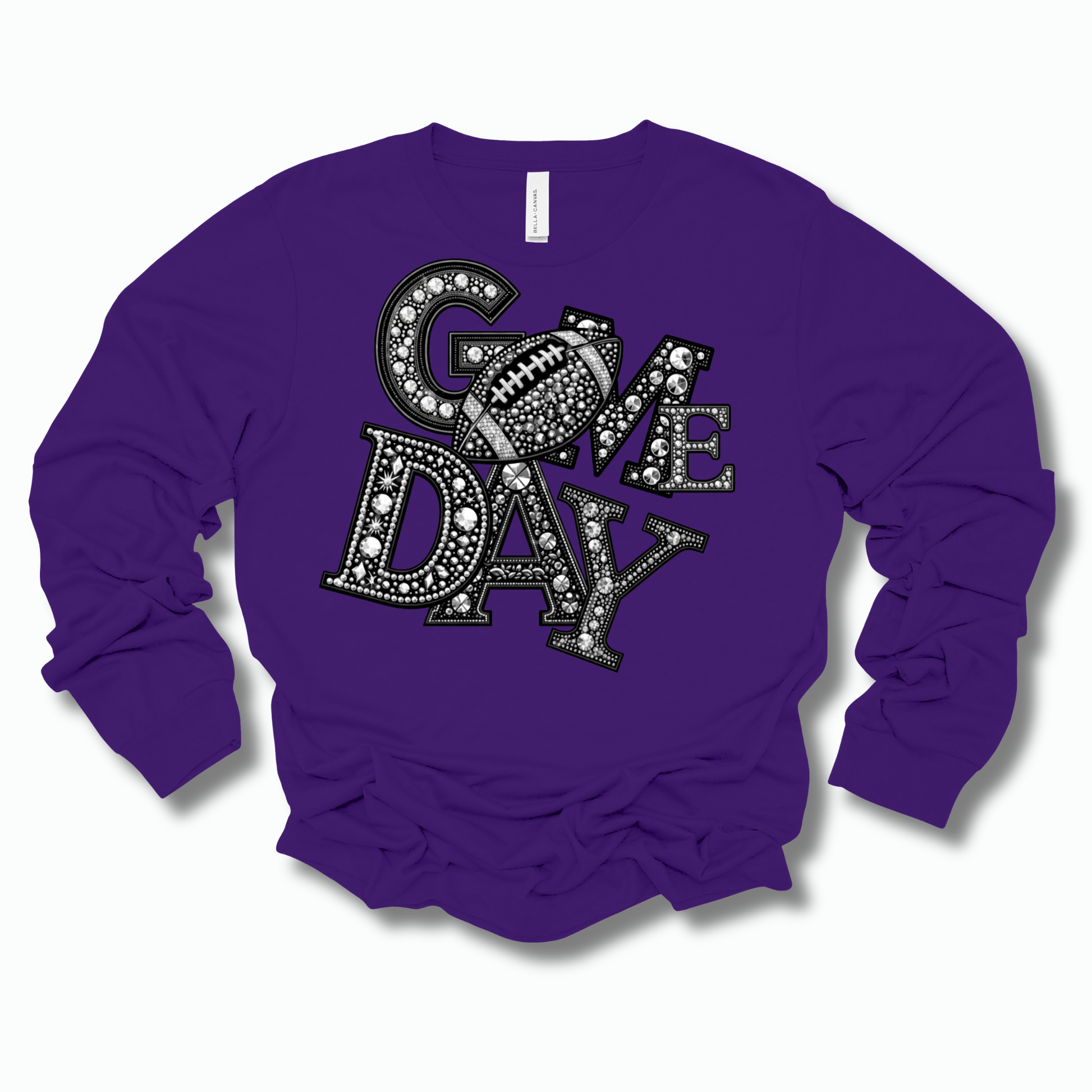 A purple long-sleeve crewneck sweatshirt with a large 'COME DAY' graphic on the front, featuring a football motif and rhinestone-like embellishments, shown on a light gray background.