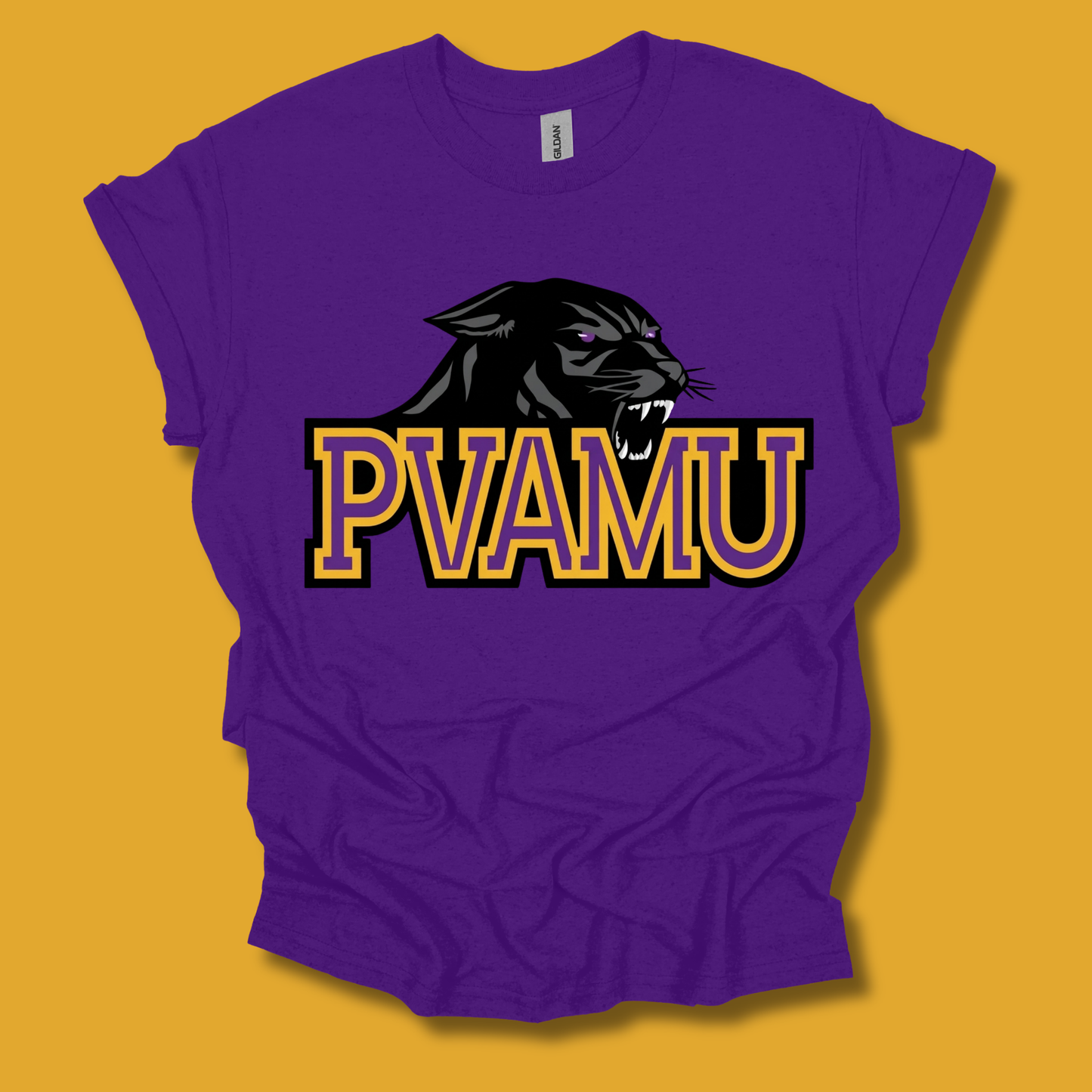 A purple short-sleeve t-shirt with a vibrant graphic print on the front. The graphic features a football surrounded by purple and gold paint splatters, with the text 'PVAMU' in gold letters.