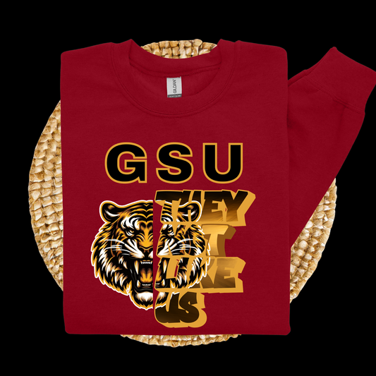 Red sweatshirt with tiger graphic and 'GSU THEY LOVE US' text on a woven surface  Grambling Football:  GSU They Not Like Us Game Day Unisex Crewneck Sweatshirt