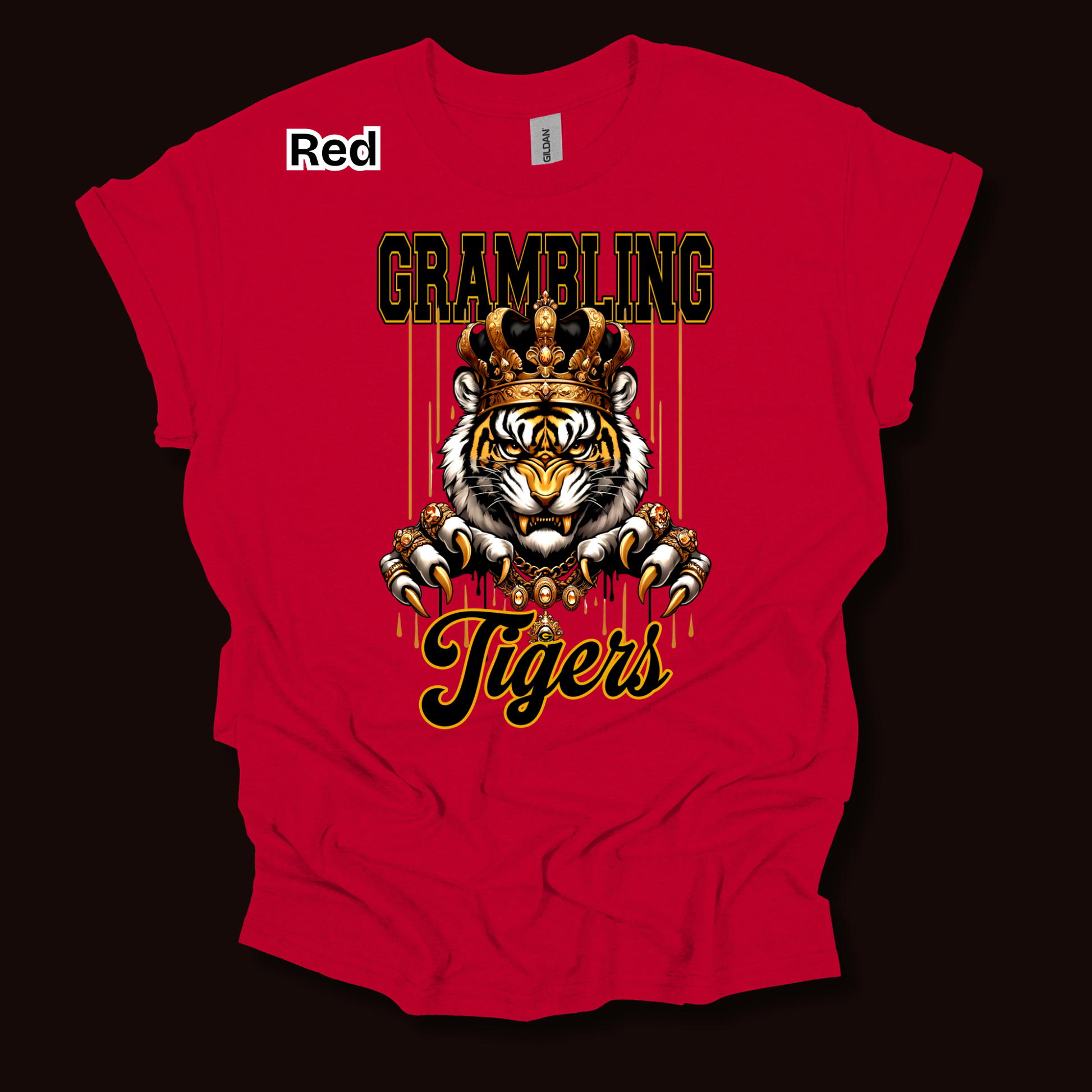 A red short-sleeve t-shirt with a graphic print of a tiger wearing a crown, with the text 'GRAMBLING' above and 'Tigers' below, displayed on a dark background.